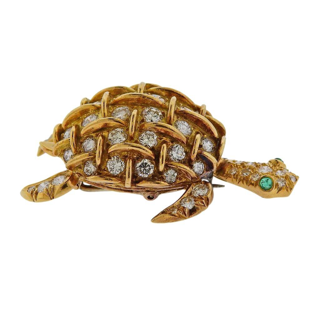 18k gold turtle brooch, crafted by Tiffany & Co in France, set with approx. 2 carats in G/VS diamonds and emerald eyes. Brooch measures 40mm x 25mm. Weight is 15.1 grams. Marked: Tiffany & Co, France, 18k.