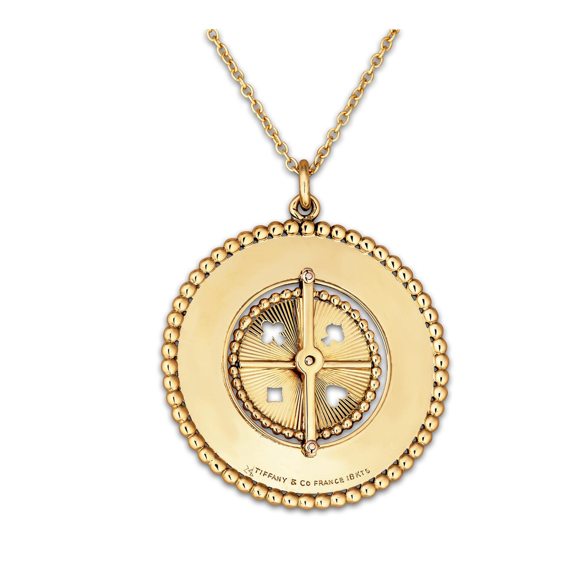 Spin the inner roulette wheel of this vintage Tiffany & Co. France 18 karat gold charm and you will always be a winner.  With the four suits of hearts, spades, diamonds, and clubs represented on the cabochon ruby topped wheel, this lucky pendant