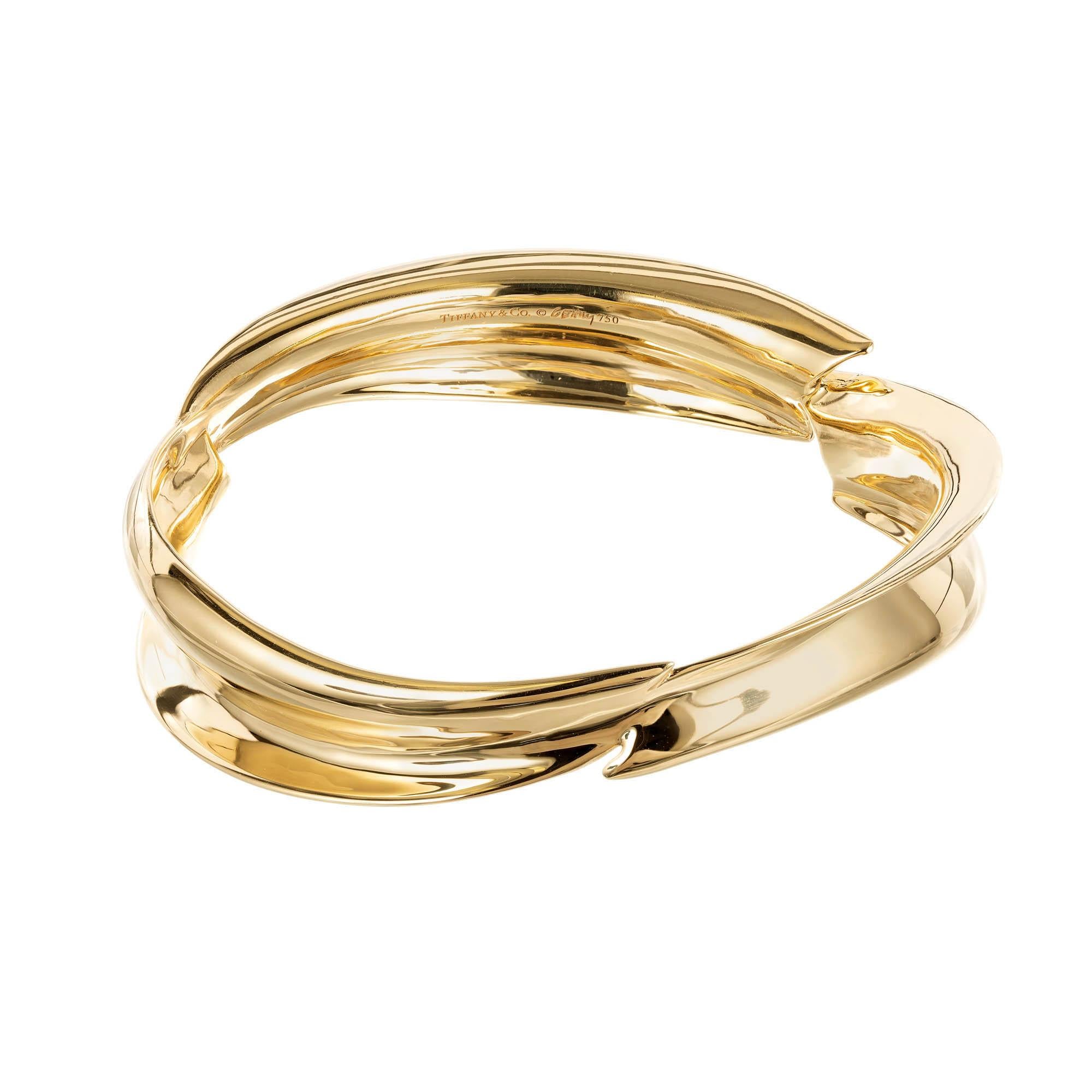 Tiffany & Co by Frank Gehry 18k Yellow Gold leaf form slip on bangle bracelet  

18k yellow gold 
Fits a 7 ½ Inch wrist
Tested: 18k
Stamped: 750
Stamped: Tiffany + Co Frank Gehry
44.3 Grams
Width: 14.4mm 
Thickness/Depth: 5.8
Inside Dimensions: 2 ¾
