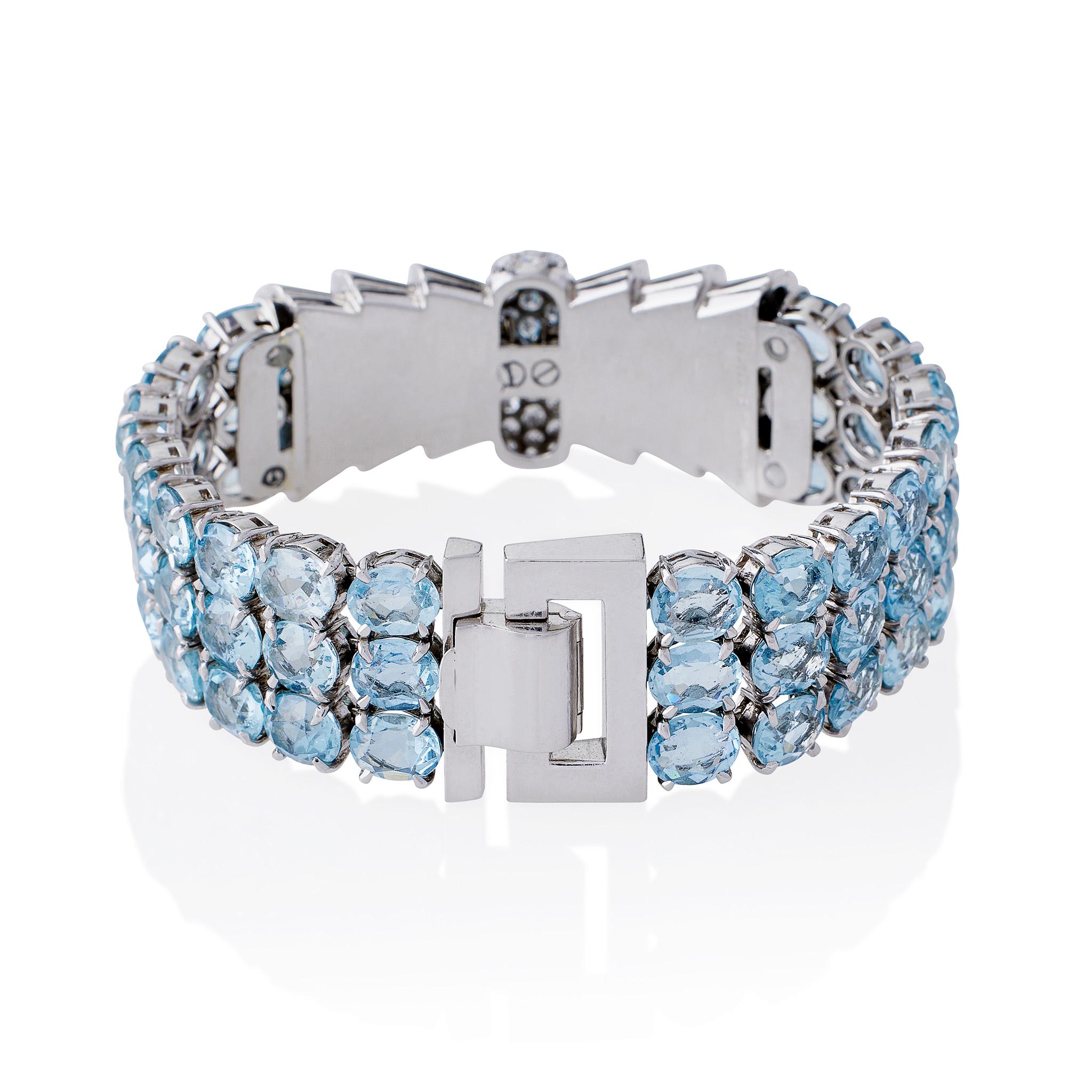 Dating from the 1930s, this Tiffany & Co. aquamarine and diamond bracelet was made in France. It is designed as strap of flexible oval-cut aquamarines, approximate total weight 32.40 carats, centering a stepped platinum ribbon bow with pavé-set