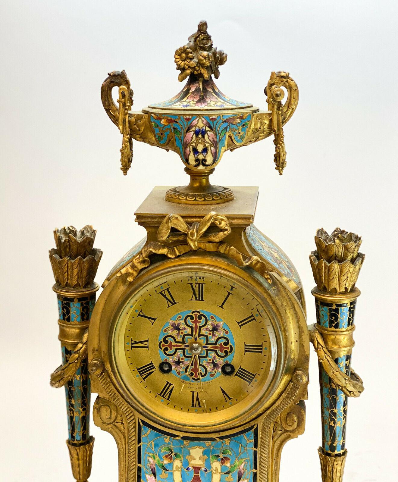Tiffany & Co. French champlevé enamel bronze clock, circa 1900. Blue floral champlevé enamel throughout with an urn to the top finial. Signed 