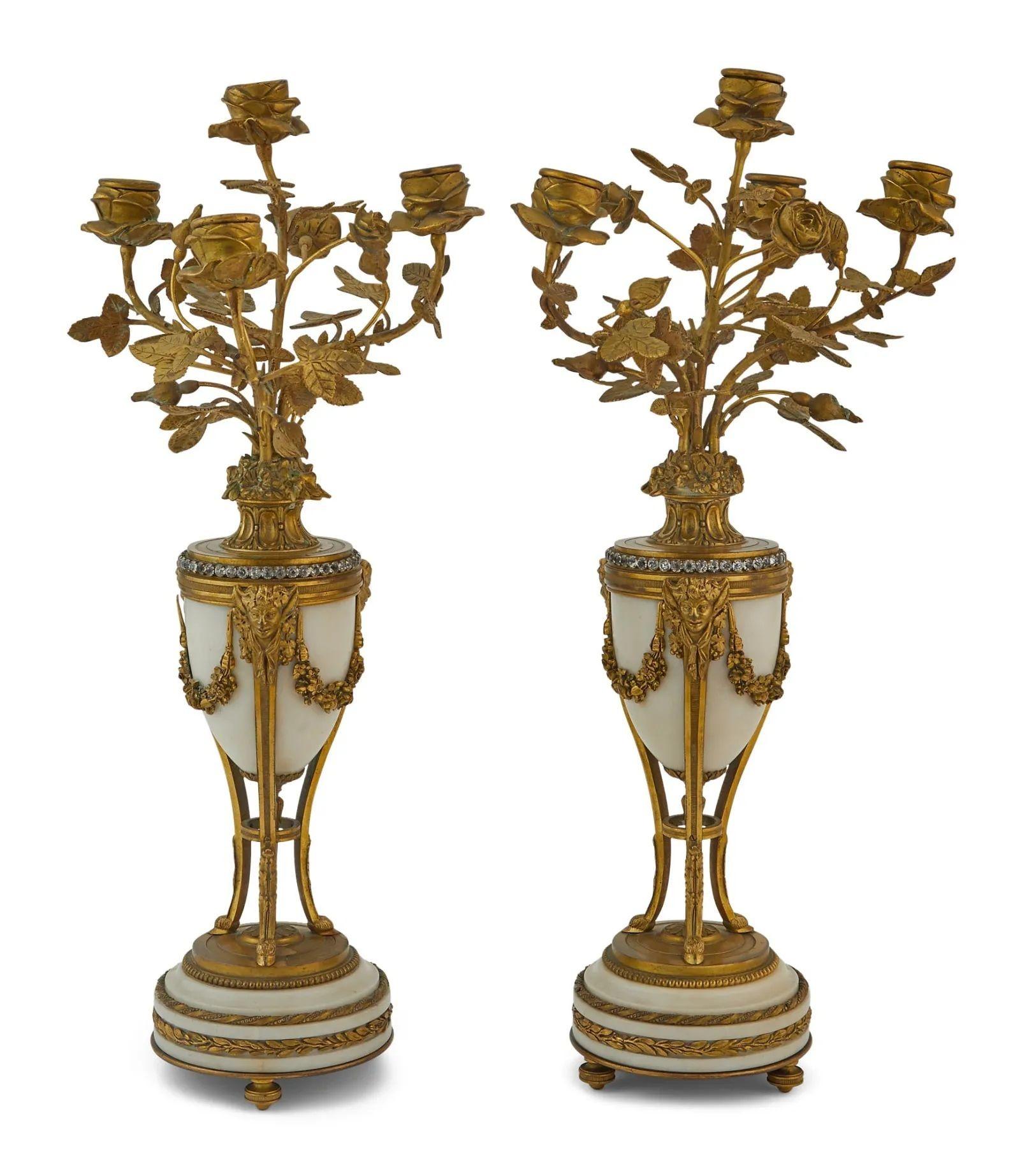 Tiffany French Louis XVI Clock Garniture Set, Bronze, Marble, 19th/20th Century
A French Louis XVI style three-piece gilt bronze and white marble clock garniture, retailed by Tiffany & Co., New York, NY, late 19th century


Comprising a clock, of