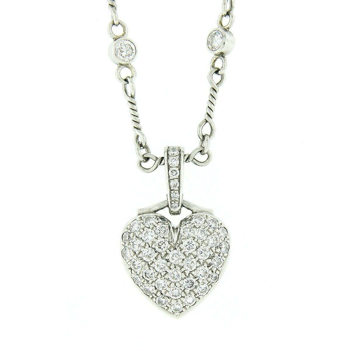 This stunning Tiffany & Co. diamond pendant necklace was crafted in France from solid platinum. It features a lovely heart shaped pendant that is drenched with approximately 0.60 carats of round brilliant cut diamonds that are pave set throughout