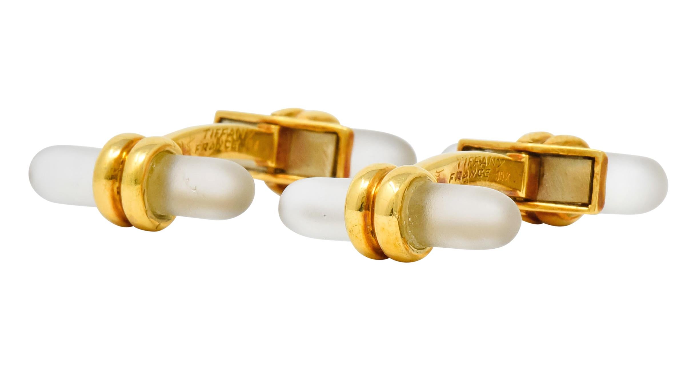 Lever style cufflinks terminating as two cylindrical rock crystal, translucent with a frosted finish

Each centrally wrapped by deeply ridged gold

Signed Tiffany France

Stamped 18k with French assay marks for 18 karat gold

Length: 1 1/8
