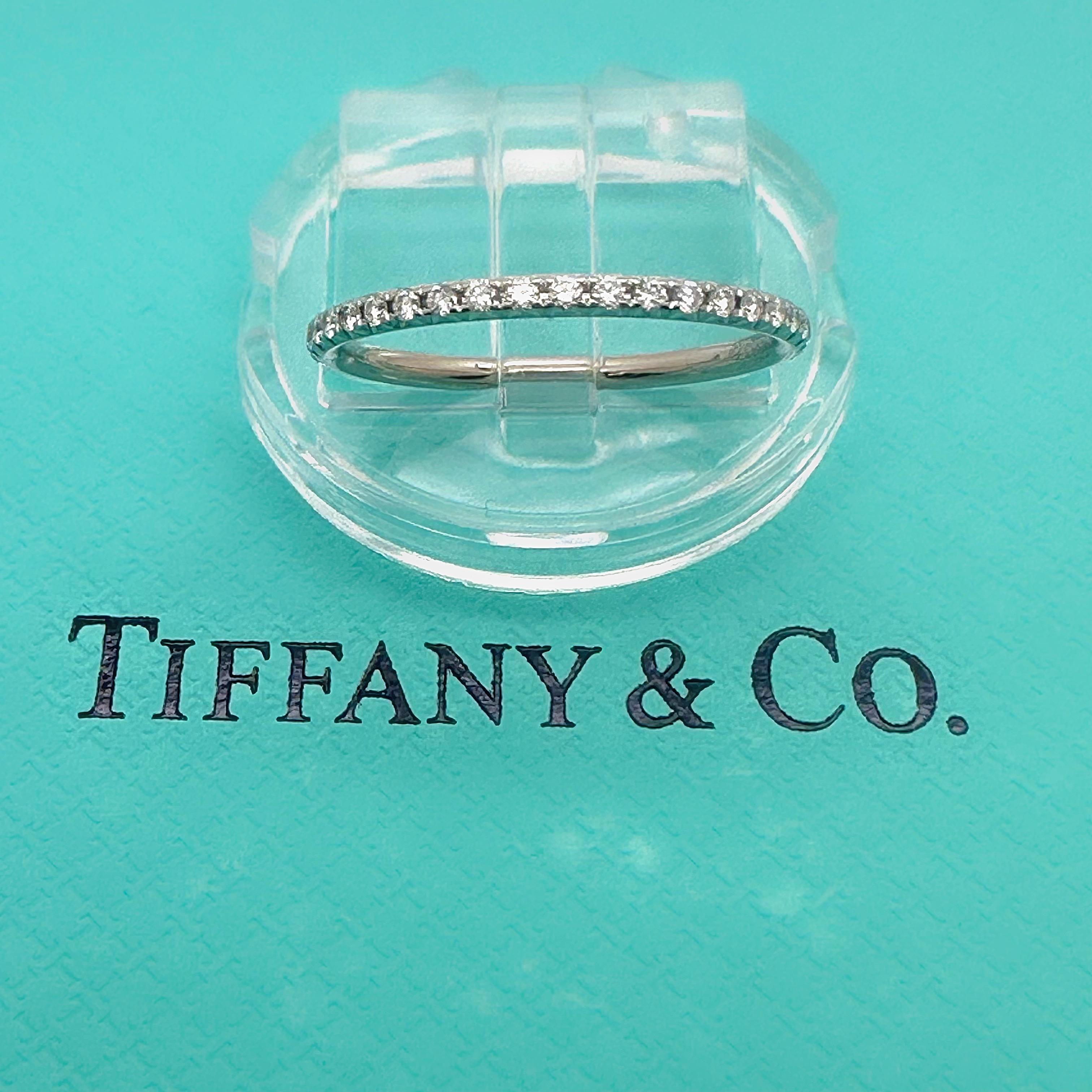 Tiffany & Co. Full Circle Diamond Eternity Band Ring
Style:  Band
Ref. number:  60003498
Metal:   18k White Gold
Width:  ~ 1.4 mm
Size:  4.75 
TCW:  ~ 0.34 tcw
Main Diamond:  Round Brilliant Diamonds
Hallmark:  ©TIFFANY&Co. Au750 BELGIUM
Includes: 