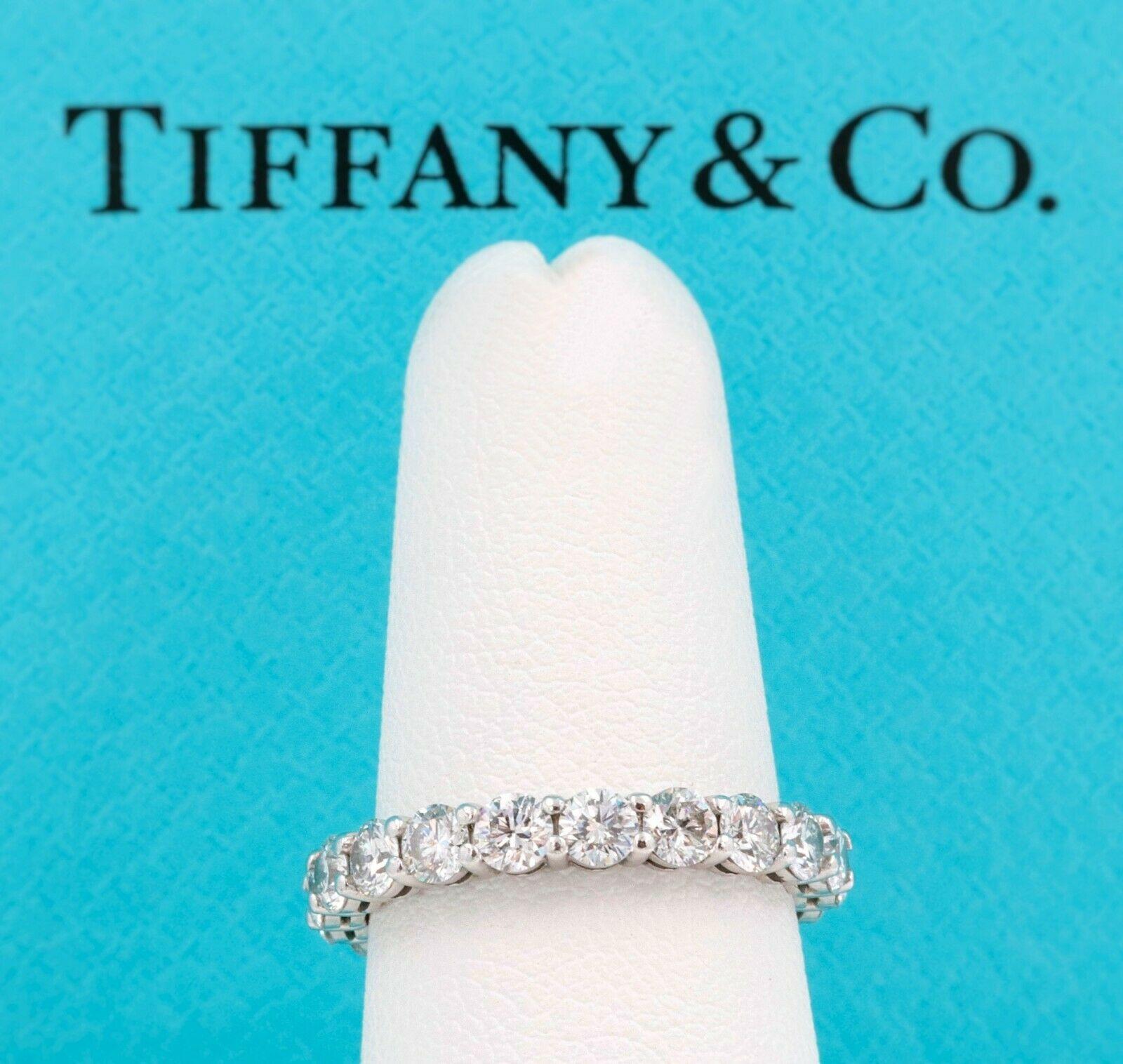 Tiffany & Co. 

Style:  Full Circle Embrace Diamond Wedding Band Ring
Metal:  Platinum PT950
Width:  3 MM
Size:  5.75
Total Carat Weight:  1.76 tcw
Diamond Shape:  20 Round Brilliant Diamonds
Diamond Color & Clarity:  G - VS2
Hallmark: 