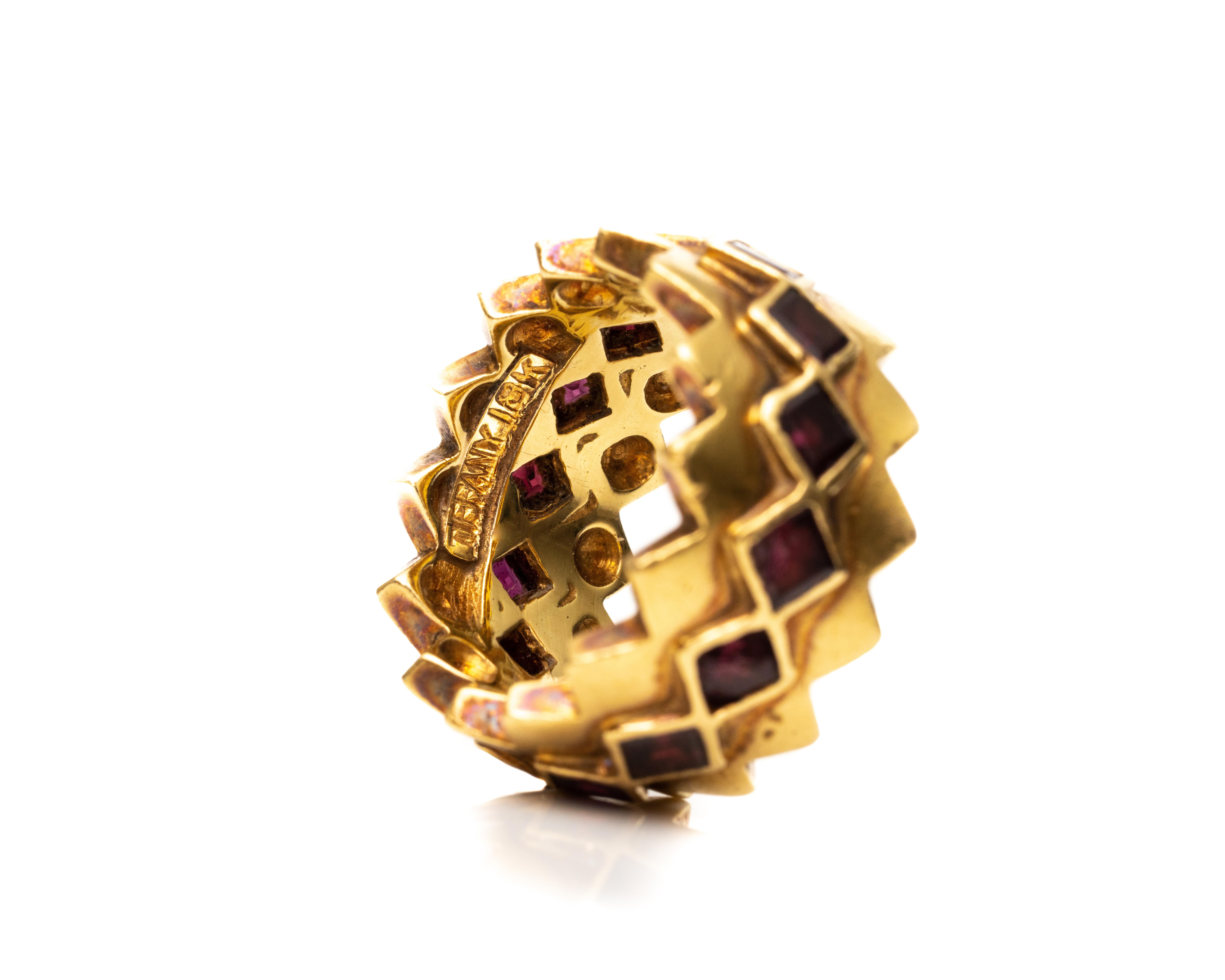 Ring Details:
Metal type: 18 Karat Yellow Gold
Size: 6.5 (not sizable)
Weight: 15 grams

Features square cut Garnets going all the way around and has a unique design overall.
The striking contrast of colors from the garnets and 18 karat gold gives