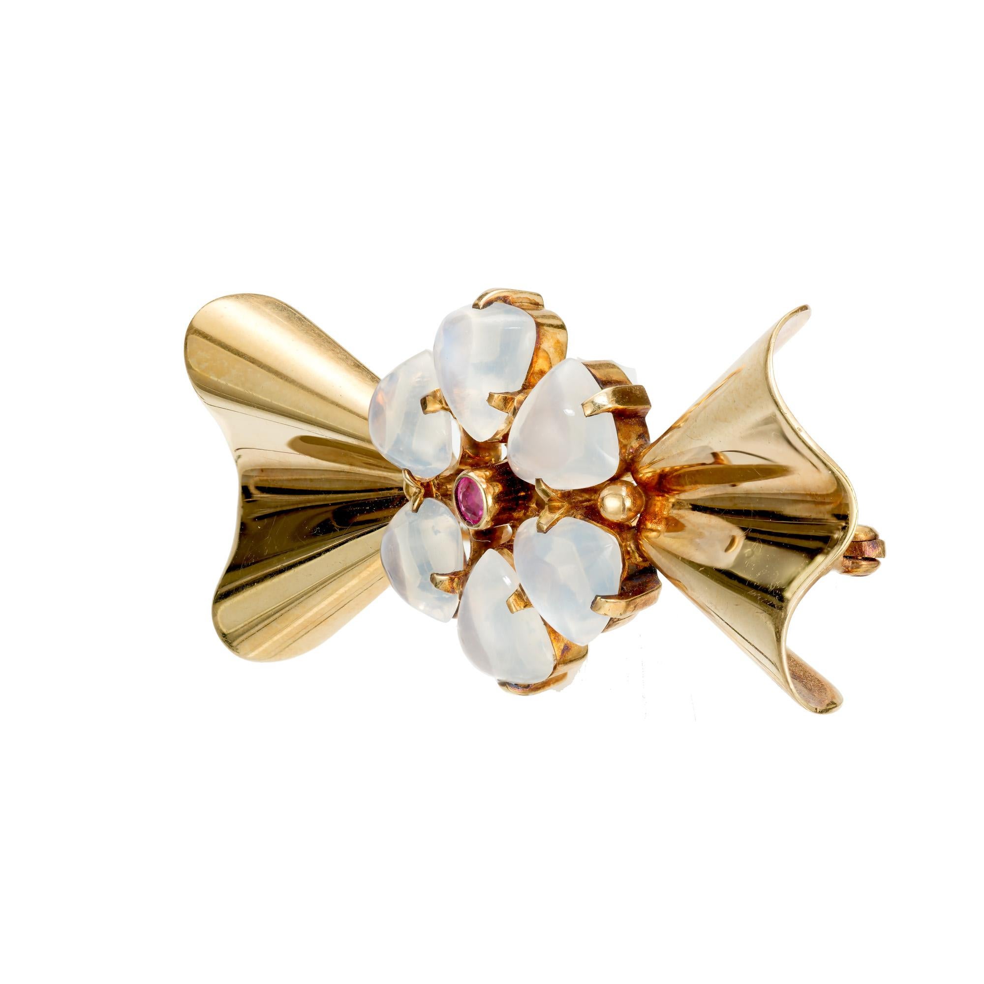 Tiffany & Co moonstone and ruby brooch. 6 fancy cut moonstones with 1 round ruby center stone, set in a 14k yellow gold brooch.  Classic example of the art of Tiffany in the late 30’s and early 40’s. Circa 1935-1945.

6 fancy cut moonstones with