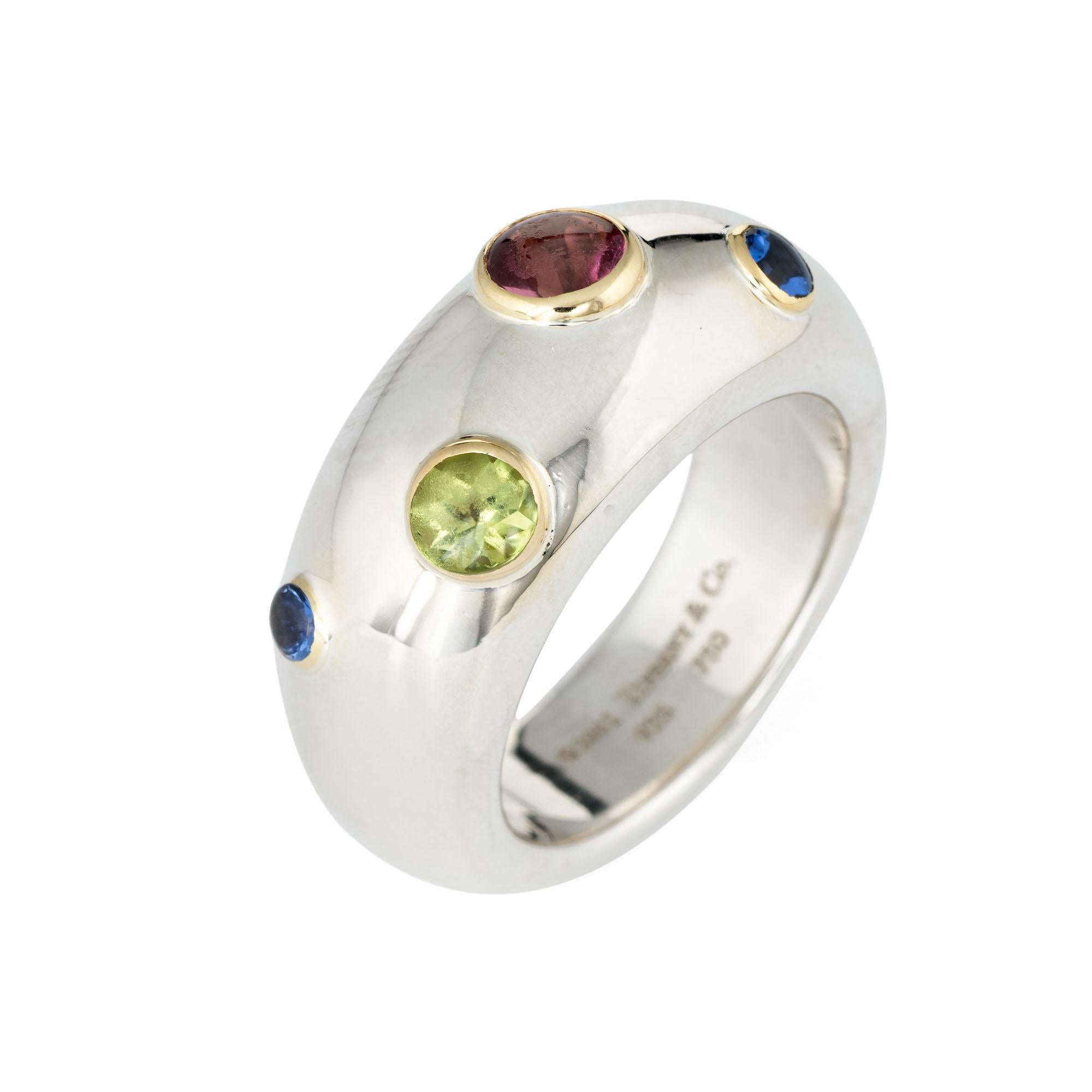 Finely detailed estate Tiffany & Co gemstone ring (circa 2001) crafted in sterling silver & 18 karat yellow gold. 

Cabochon cut sapphire, peridot & pink tourmaline range in size from 0.10 to 0.40 carats. The total gemstone weight is estimated at