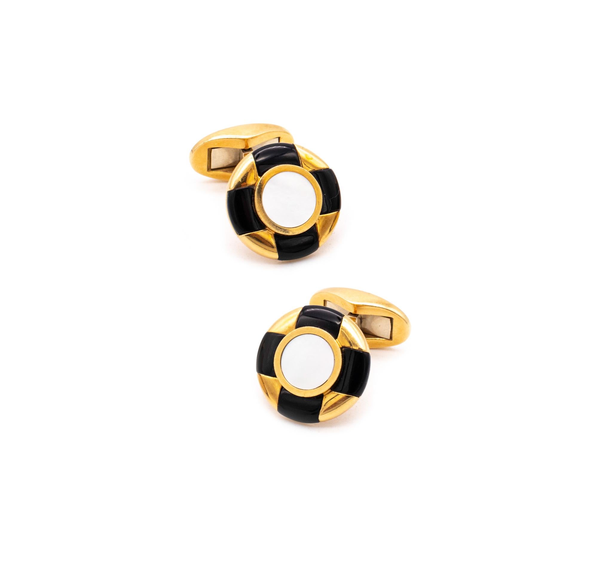Elegant pair of cufflinks designed by Tiffany & Co.

Handsome jeweled pair, crafted in solid 18 karats of high polished yellow gold and suited with a hinged movable T bar.

Embellished, with a geometric patterns, created from carvings of natural