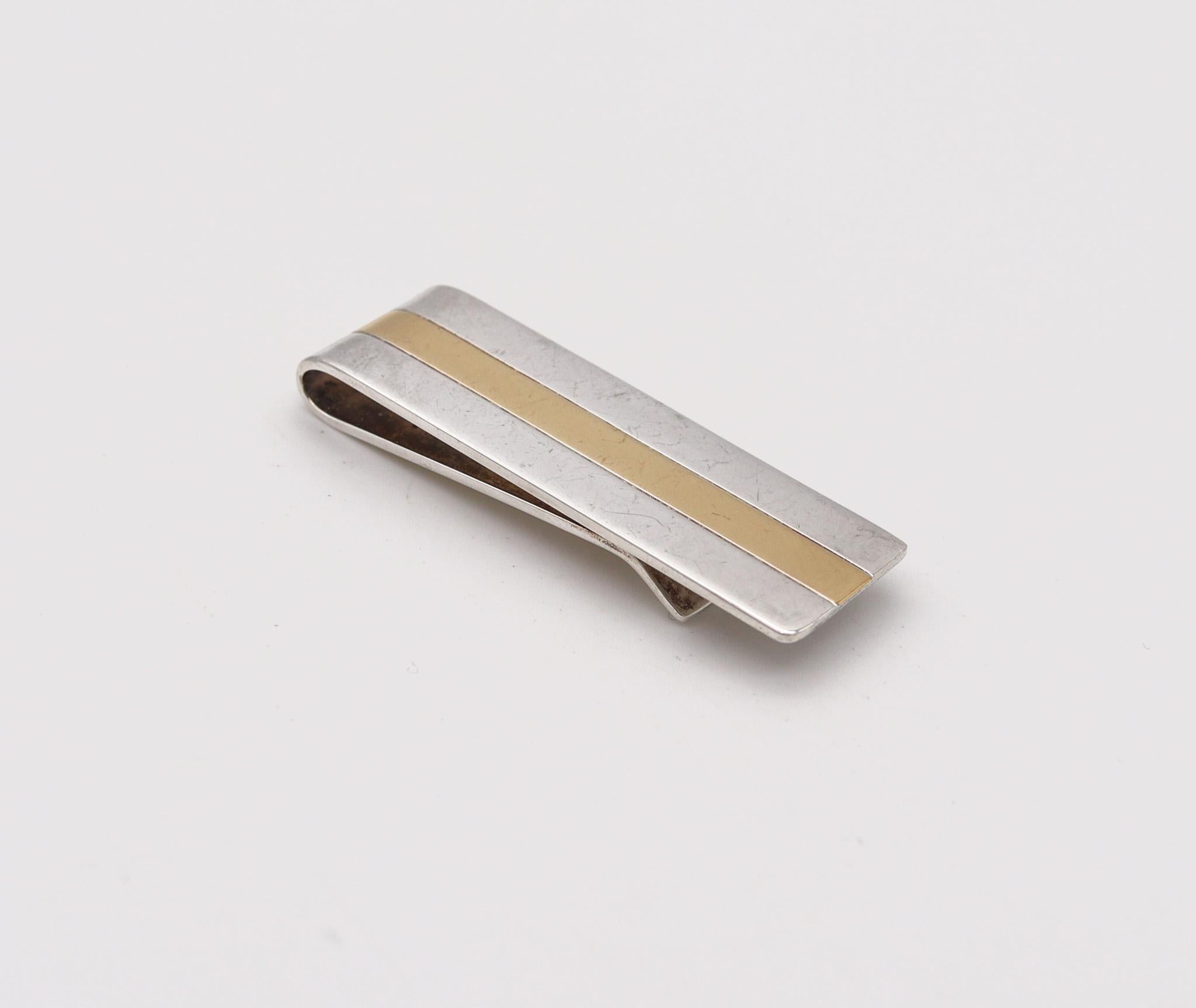 Money clip designed by Tiffany & Co.

Beautiful geometric money clip, created in New York by the jewelry house of Tiffany & Co. The money clip is crafted in solid .925/.999 sterling silver and yellow gold of 18 karats with all parts in high polished