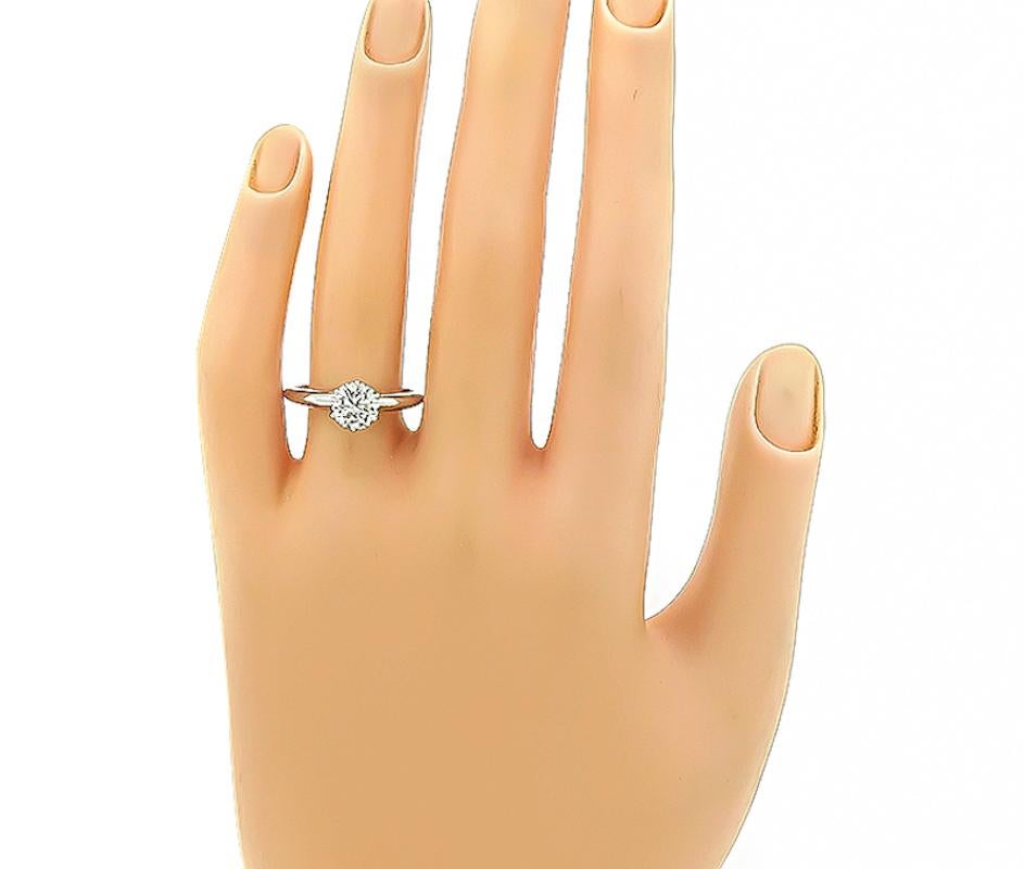 This is a stunning platinum solitaire engagement ring by Tiffany & Co. The ring is centered with a sparkling GIA certified round cut diamond that weighs 0.99ct. the color of the diamond is I with VS1 clarity. The ring is signed Tiffany&Co IRIDPLAT