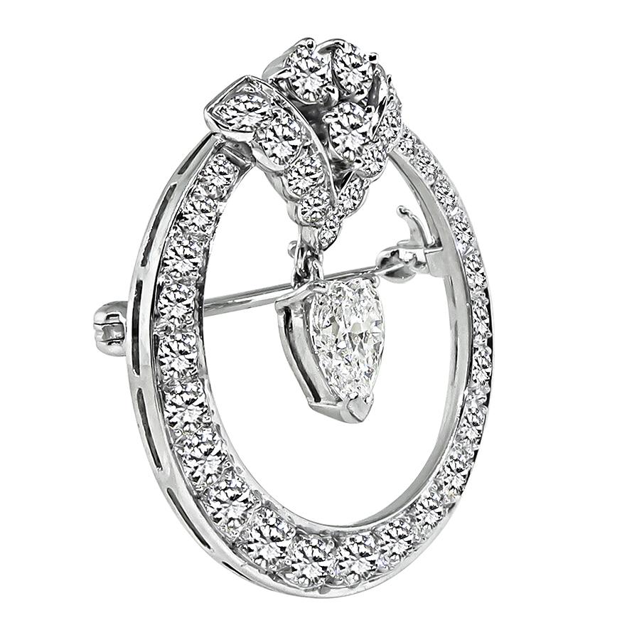 This is an elegant platinum pin by Tiffany & Co. The pin is centered with a sparkling GIA certified heart shape diamond that weighs 1.20ct. The color of the diamond is D with VVS2 clarity. The center diamond is accentuated by sparkling round cut