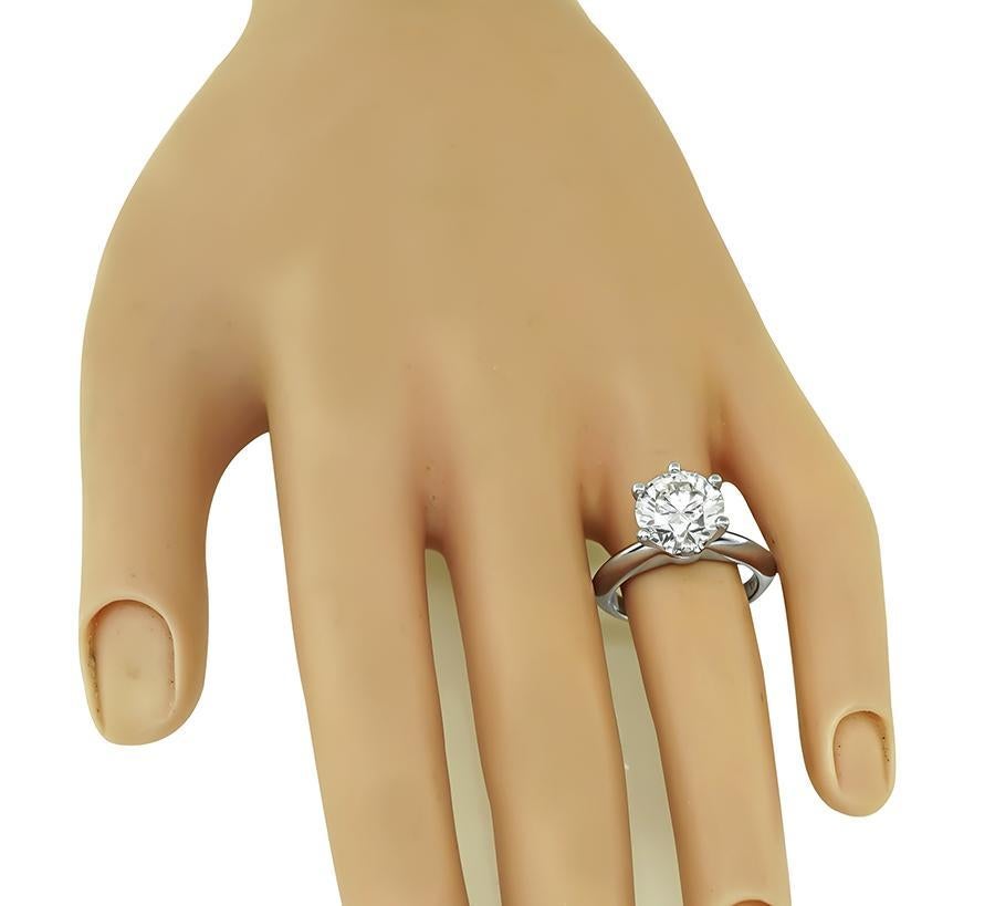 This is a stunning platinum solitaire engagement ring by Tiffany & Co. The ring is set with sparkling GIA certified round brilliant cut diamond that weighs 3.40ct. The color of the diamond is H with VVS1 clarity. The top of the ring measures 11mm in