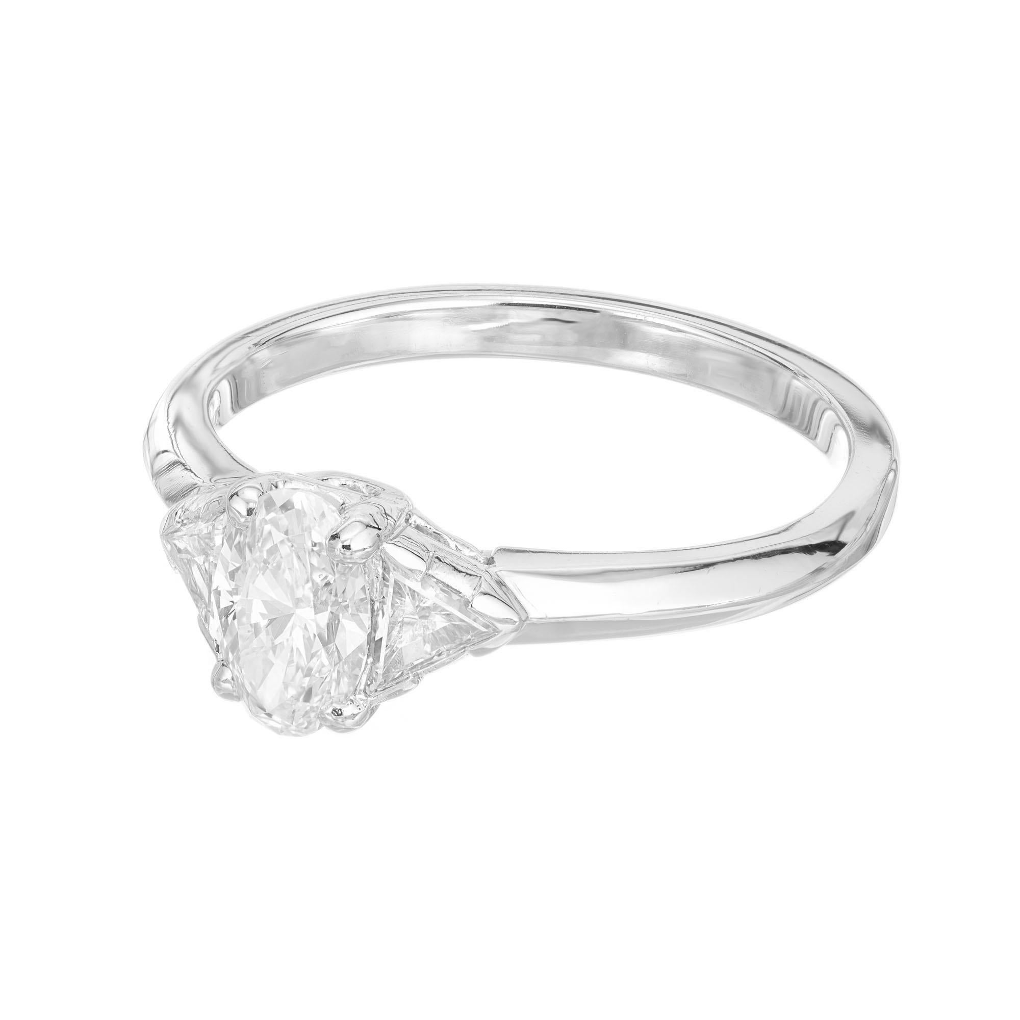 Tiffany & Co Platinum oval engagement ring. GIA certified oval center stone in a platinum three-stone setting with two trilliant cut side diamonds. Diamond removed and reset for GIA certification. 

1 GIA certified oval diamond, 0.58 cts, D, VS1,