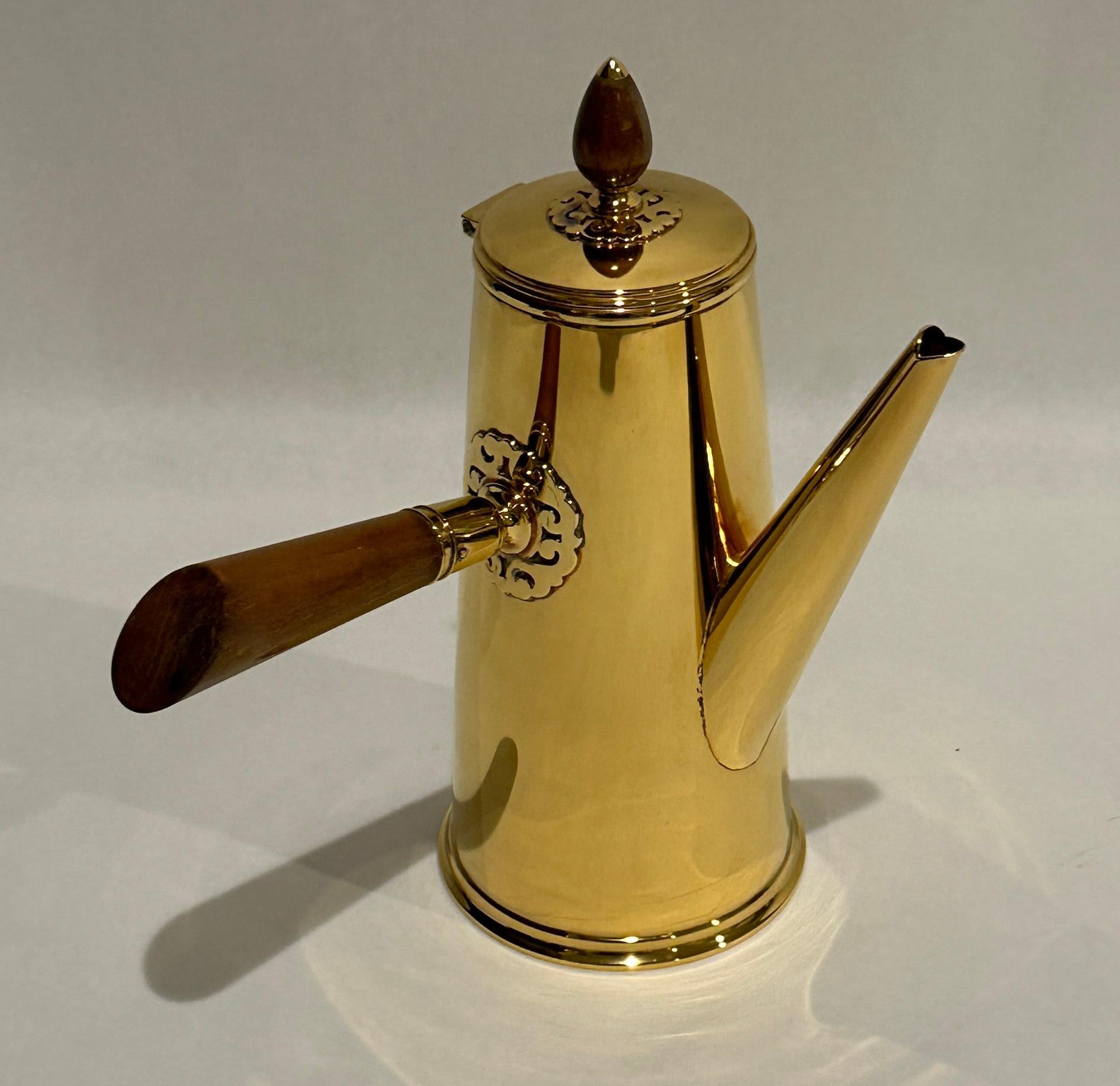 Unusual and fine quality Vermeil Tiffany & Co. sterling silver chocolate pot with turned wood handle and finial set into decorative appliqué.