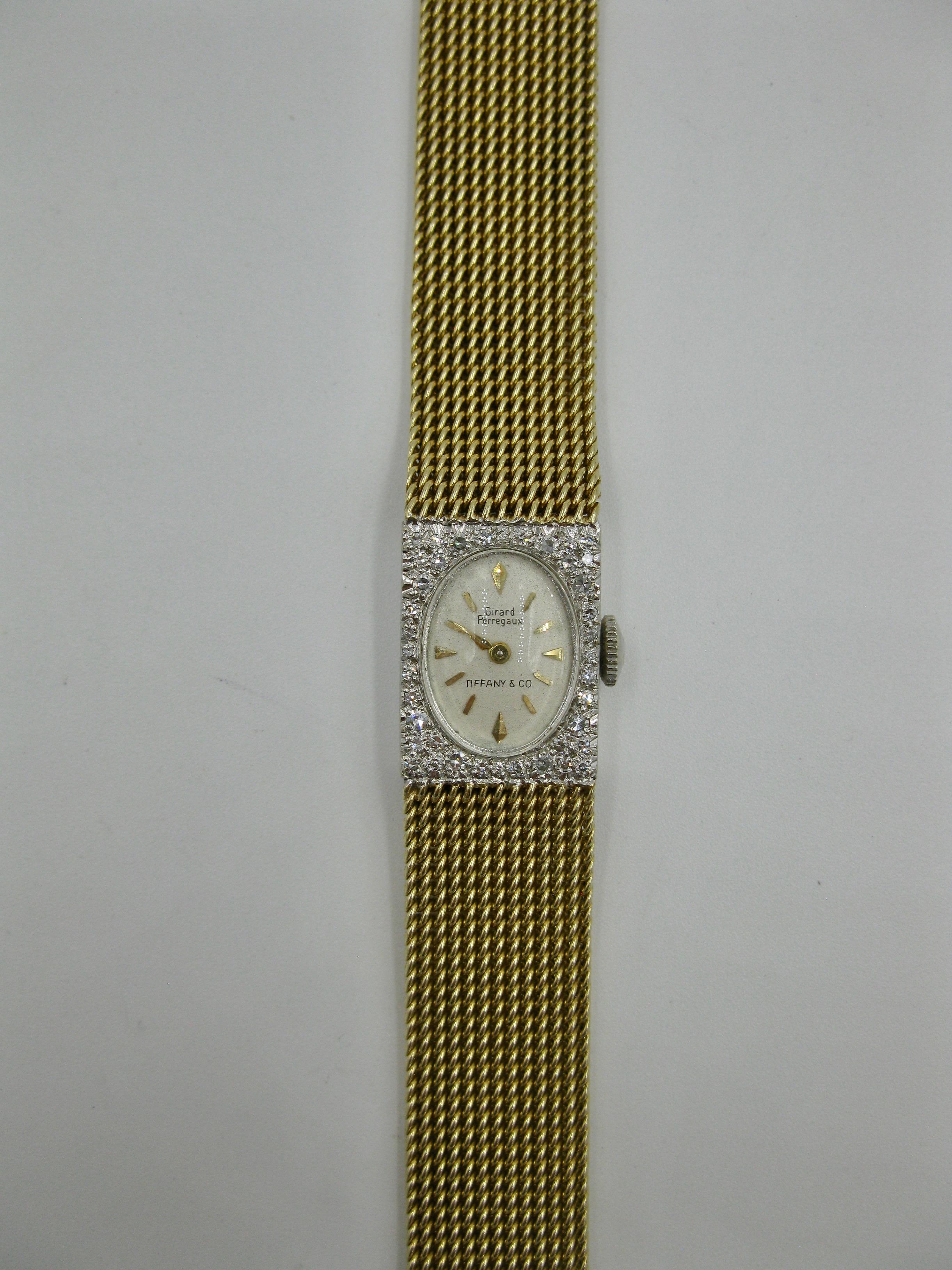 This is a gorgeous Tiffany & Co Girard Perregaux Ladies Diamond Wristwatch in 14 Karat Gold.  The watch portion is 14K white gold set with 30 radiant round brilliant cut Diamonds.  The band is a yellow gold Girard Perregaux Mesh Band signed G/P.  