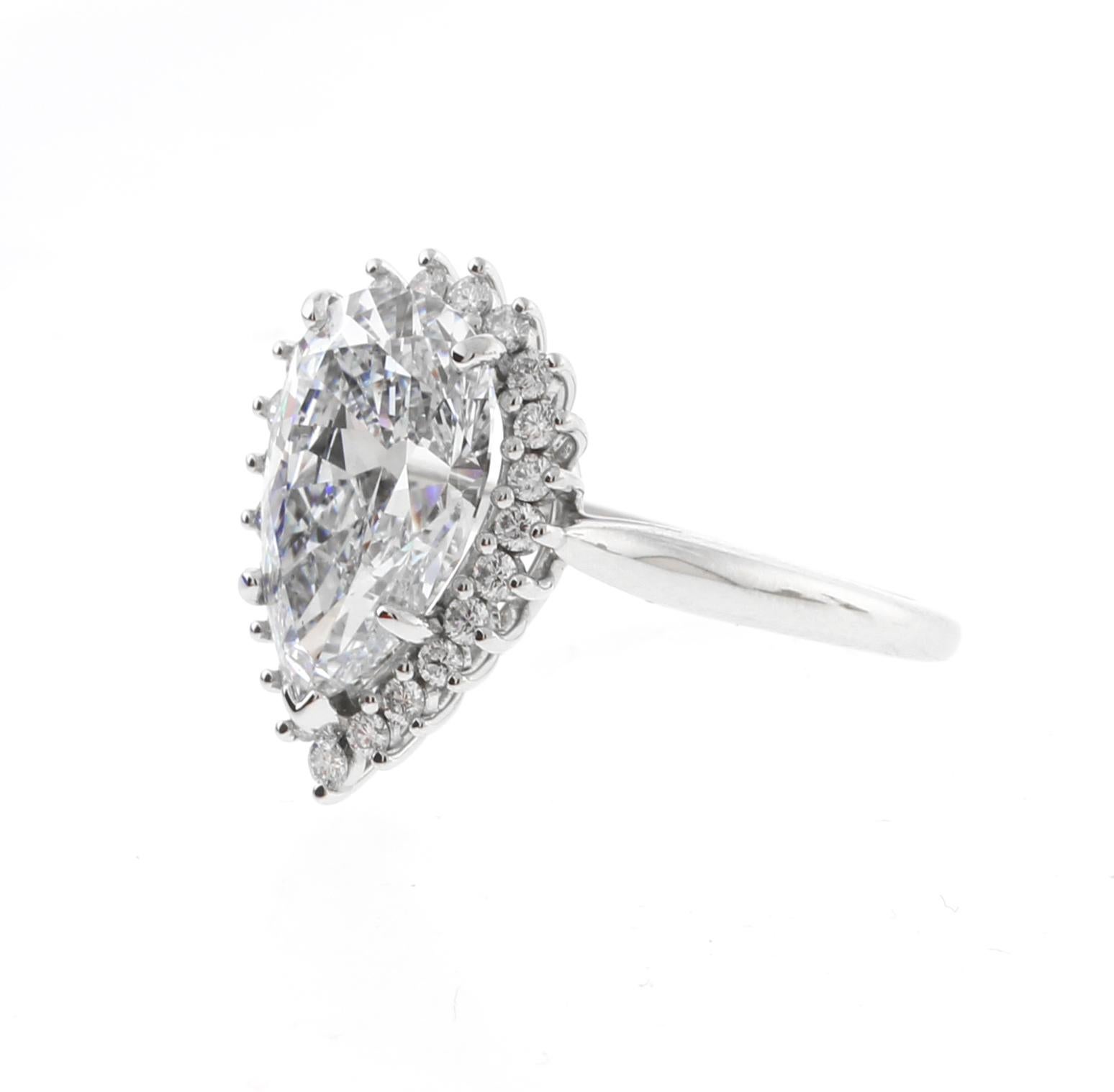 This stunning Tiffany & Co. ring features an exceptional 3.27 carat pear-shaped Golconda diamond of unparalleled brilliance and rarity. The  certified GIA diamond is D color and SI1 clarity and is elegantly surrounded by a halo of 23 meticulously