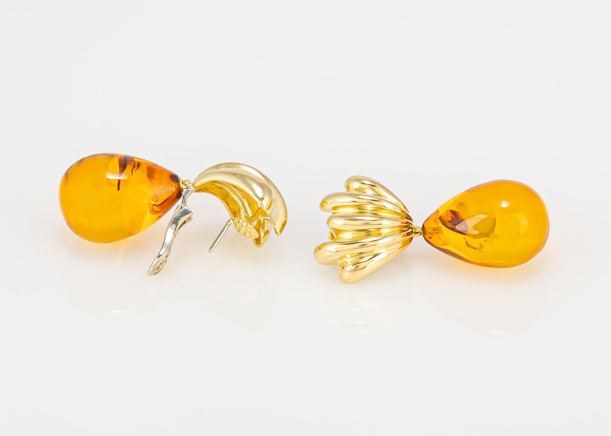 Tiffany & Co. designed an all the time pair of drop earrings with a twist. Still neutral but featuring amber drops that bring a bit of moonlight and sunshine to brighten up your day. 1 3/4's in length. Day to evening enjoyment.