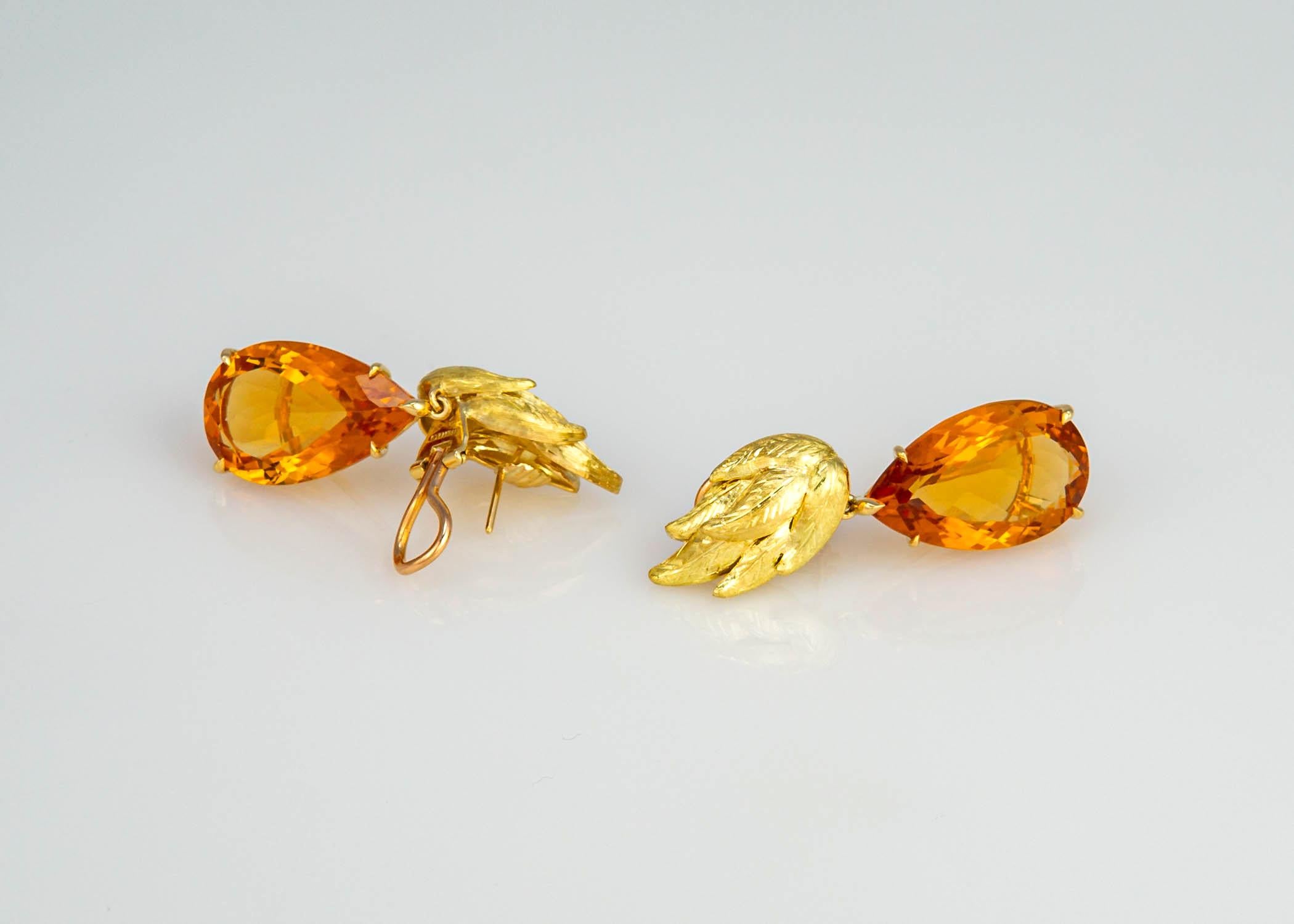 A fabulous vintage example of Tiffany & Co. style and quality. A design to dress up or wear casual. A beautifully detailed leaf motif top and a matched pair of rich honey colored citrines totaling 42 carats. Two inches in length. 