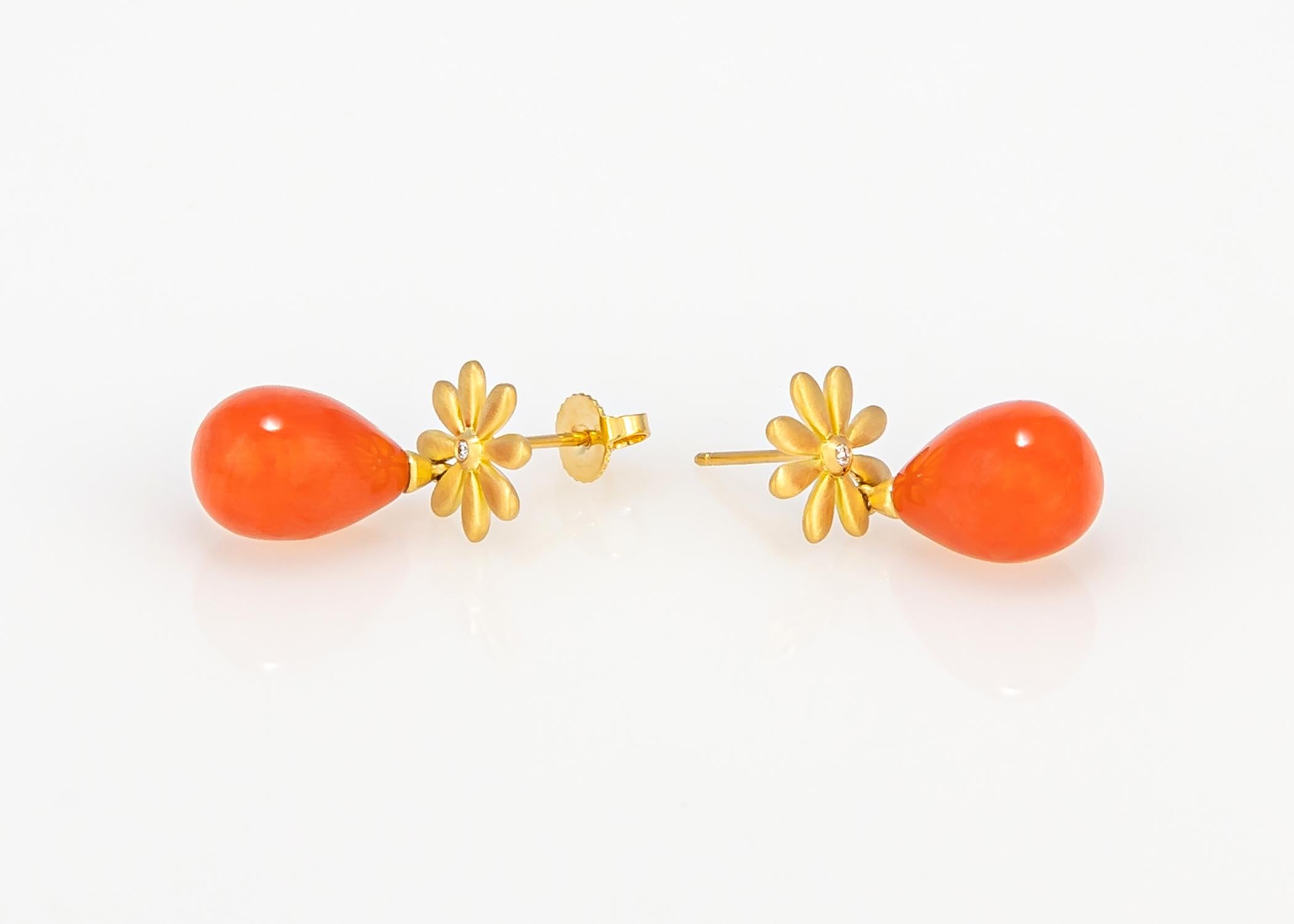 Tiffany & Co. quality and design. At just one little inch in length this gold daisy with it diamond center and vivid orange coral drops will brighten your face and perhaps your day. Chic & simply smart !!!