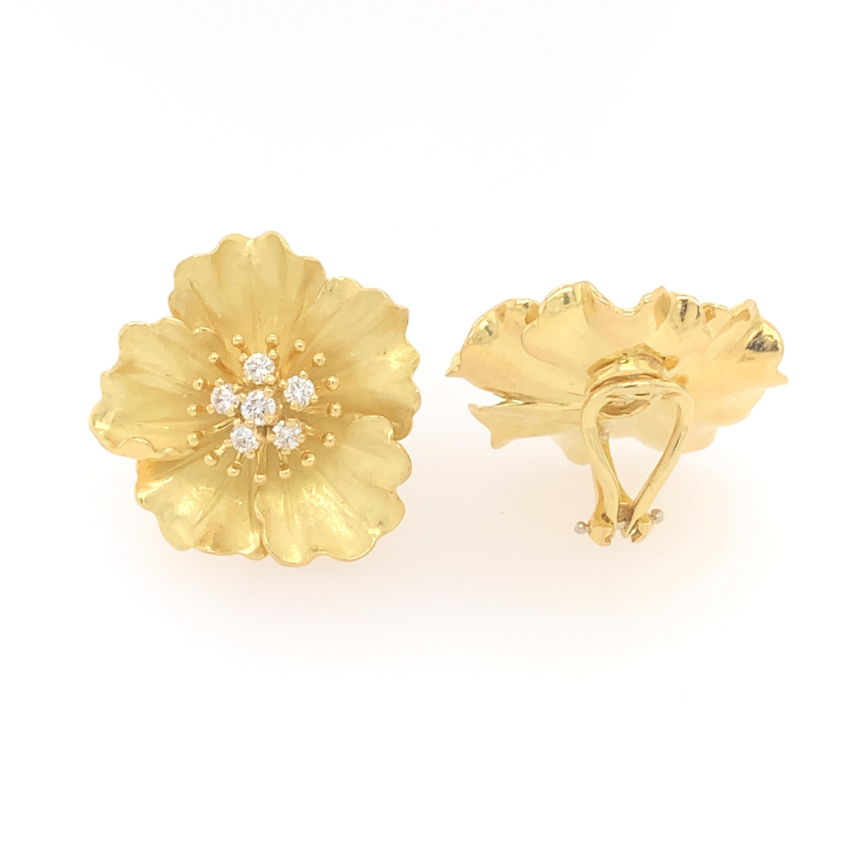 This breathtaking, vintage pair of earrings from Tiffany & Co.'s American Perennials collection features dogwood flowers with a satin, textured finish and clip-on closures. These stunning dogwood floral earrings are crafted in 18K yellow gold, and