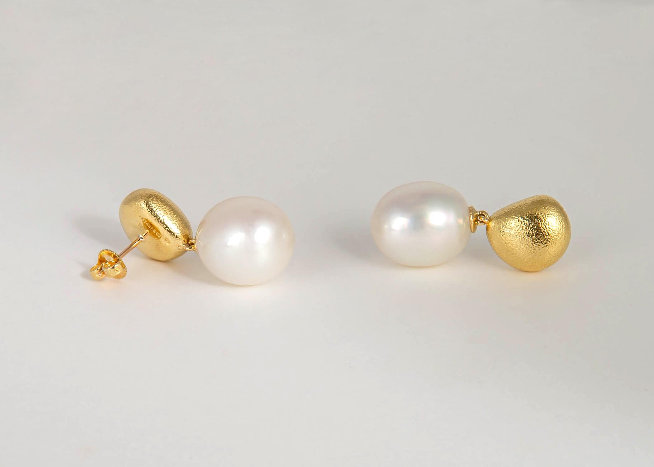 A playful easy to wear design from Tiffany & Co. A matched pair of beautiful South Sea pearls is suspended from textured gold pebble shaped tops. Simply Chic !!! Just a little bit over 1 1/4's in length.