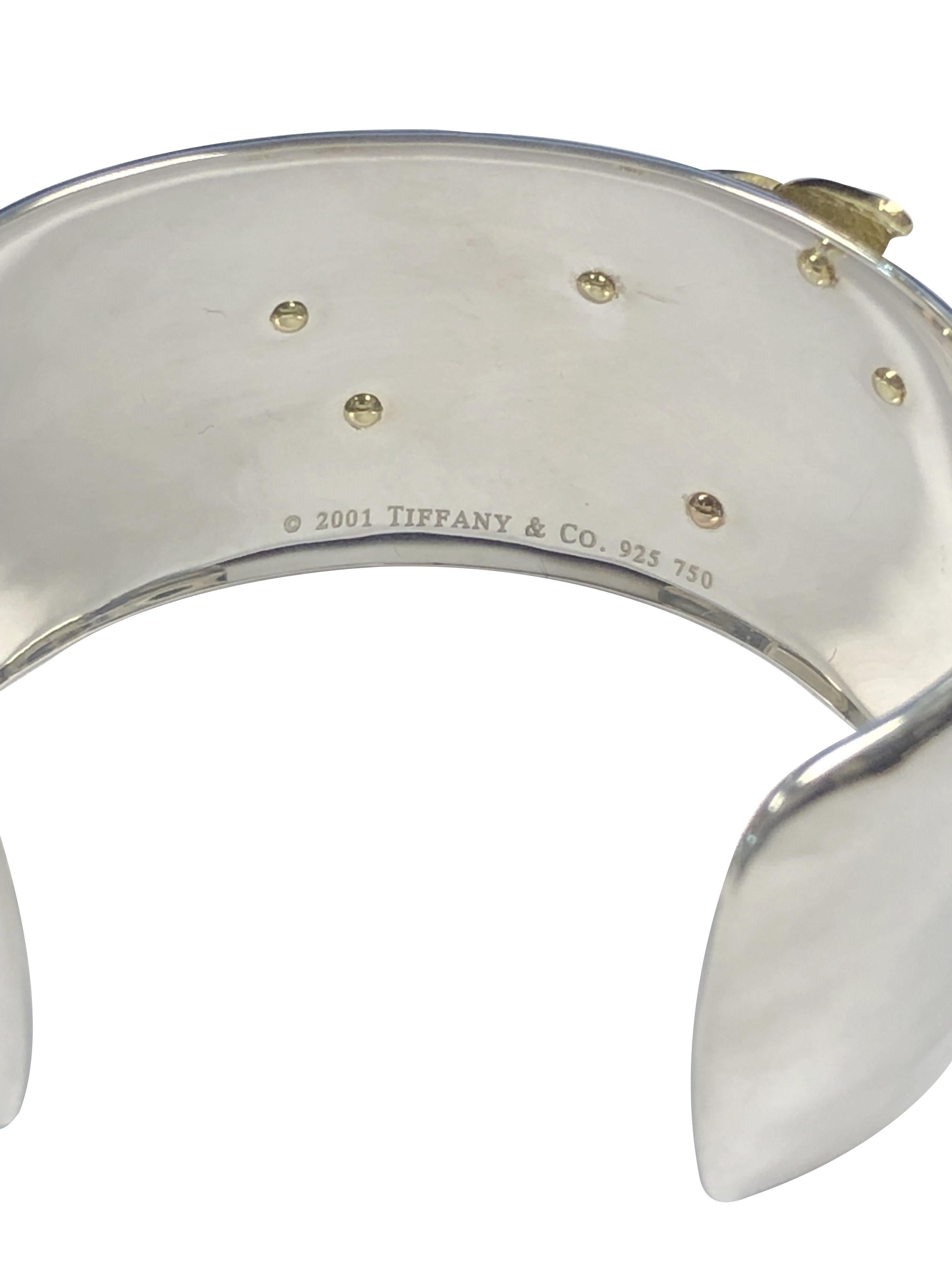 Circa 2005 Tiffany & Company Dragonfly Cuff Bracelet, Hand Hammered Sterling Silver and measuring 1 1/8 inch wide, applied, heavy and very detailed 18K Yellow and Rose Gold Dragonfly. Wrist size 6 inches with a 1 1/8 inch opening and is slightly