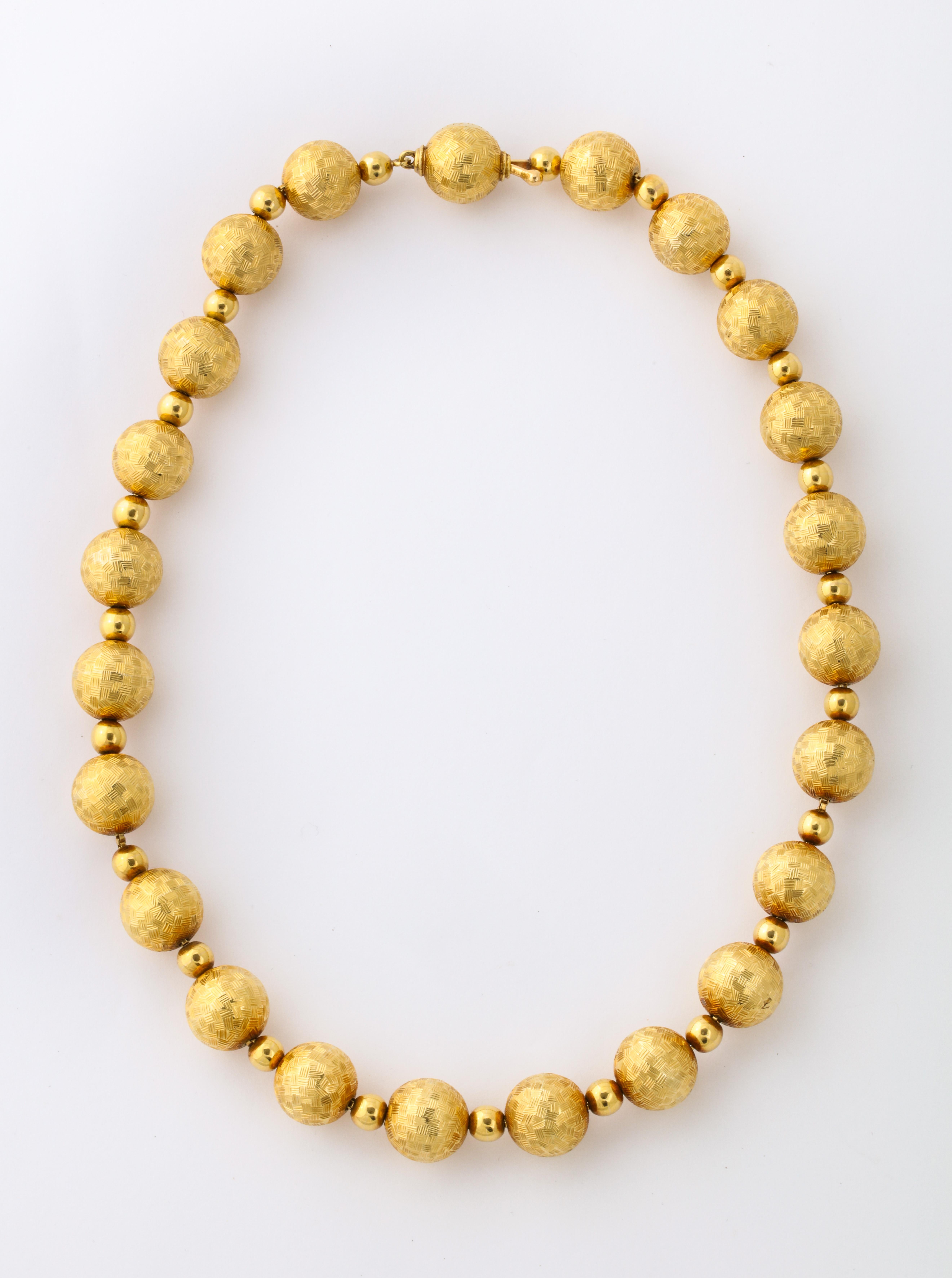 What better to bring a smile to your face than a beautiful necklace made of large gold balls, and who could be better than Tiffany to have made it.   Alternating large and small, textured and polished, gold beads all in 18kt.