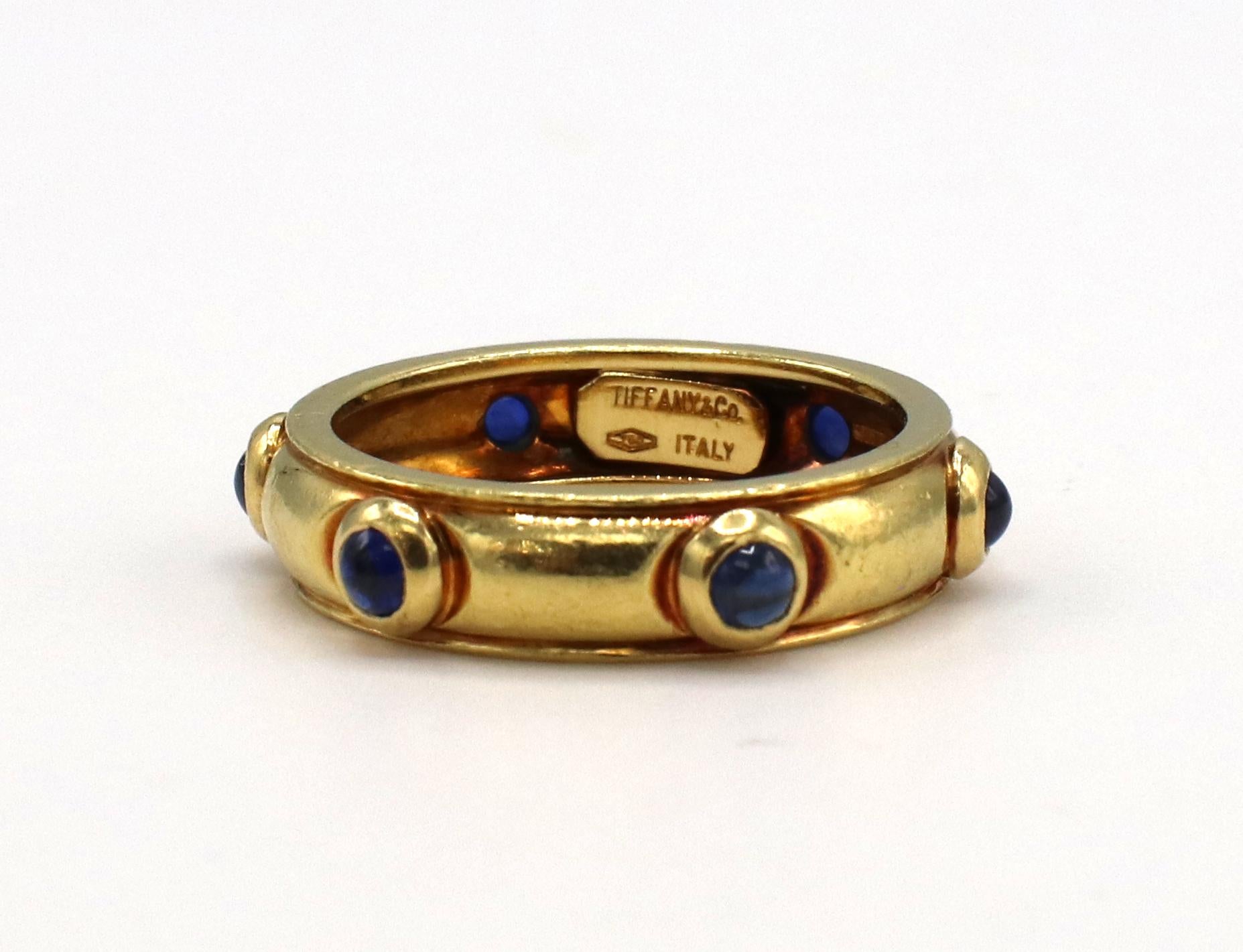 Tiffany & Co. Gold Blue Sapphire Cabochon Dome Band Ring 
Metal: 18k yellow gold
Weight: 6.35 grams
Size: 7.5 (US)
Width: 5mm 
Signed: Tiffany & Co. 750 ITALY