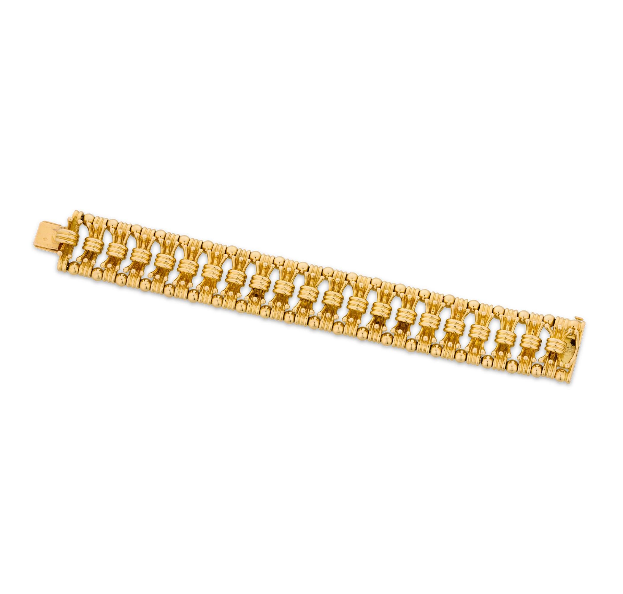 This sophisticated 18K yellow gold Tiffany & Co. bracelet features a uniquely artful design by the famed Jean Schlumberger. Crafted from a series of delightful bow ties, the bracelet undulates with dynamic movement on the wrist. Tiffany jewelry by