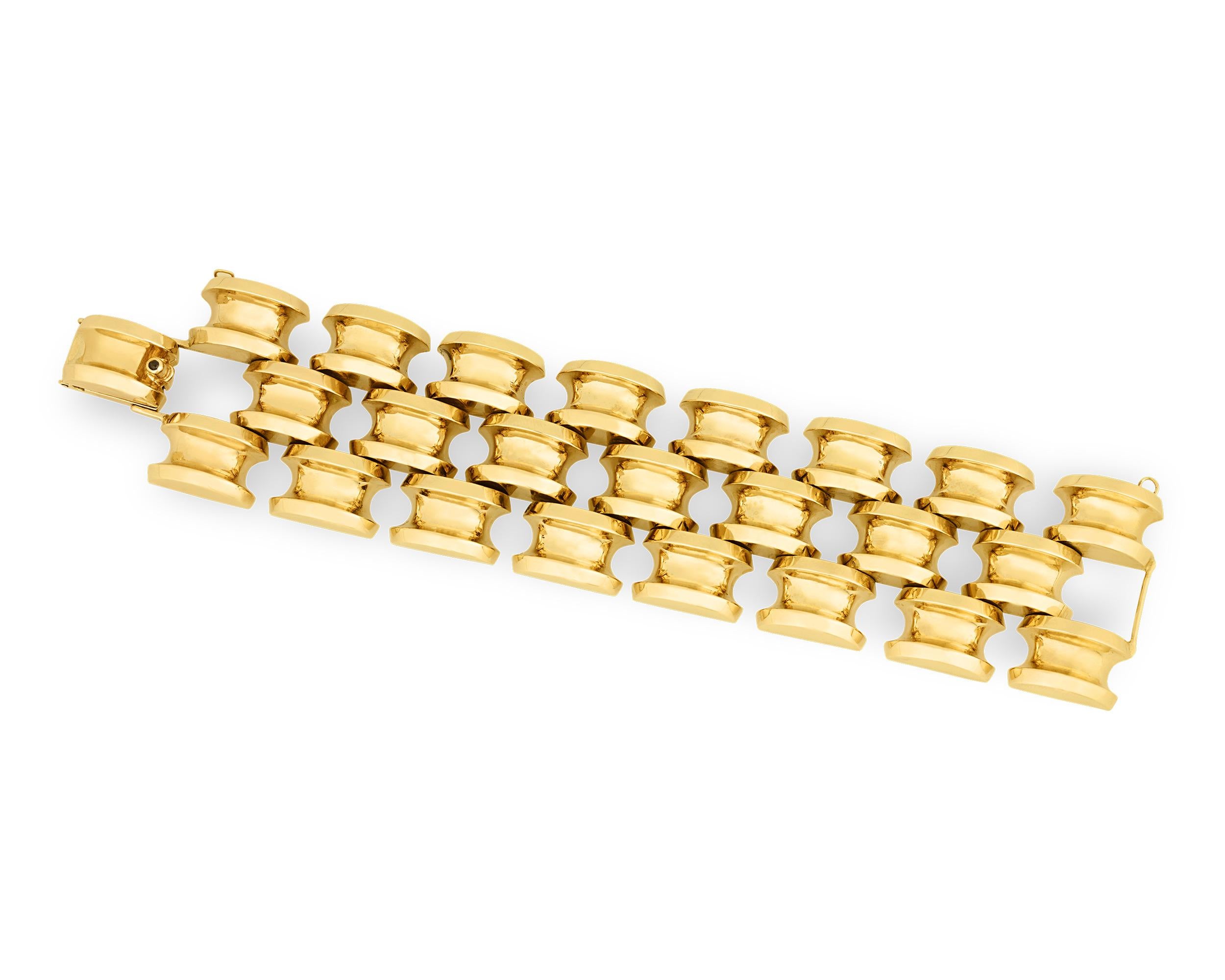 Bold and sophisticated, this elegant 14K yellow gold bracelet by Tiffany & Co. showcases the chic and fashionable side of the classic jeweler. Crafted of three large strands composed of artful oversized links, this bracelet embodies the expert