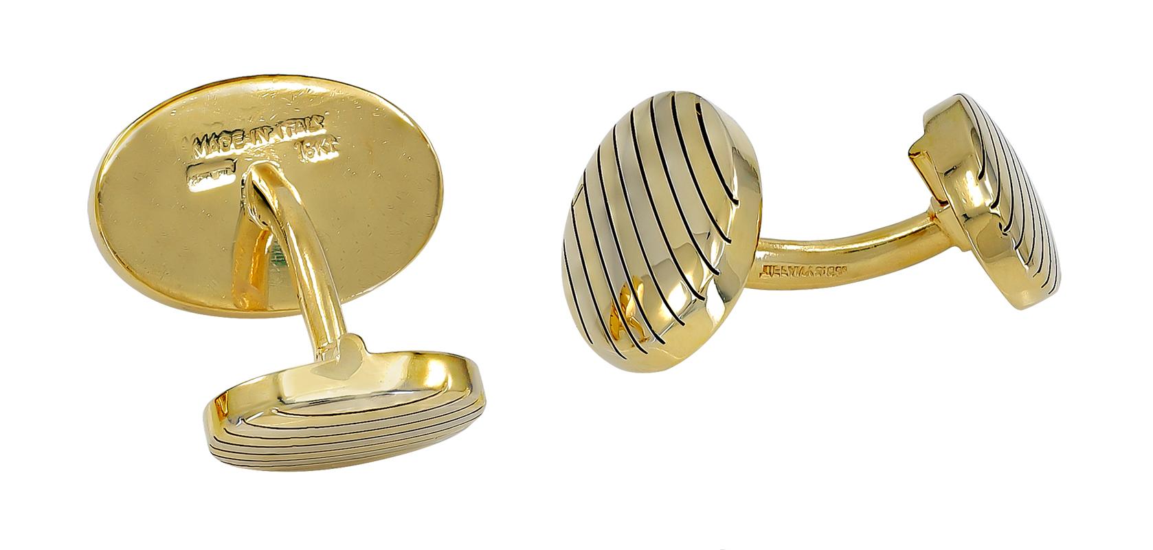 Distinctive oval cufflinks.  Made and signed by TIFFANY & CO.  Exceptionally heavy gauge 18K yellow gold.  Large striped pattern oval in front; smaller oval on reverse side. The small oval flips down for seamless insertion.  Classic and polished.