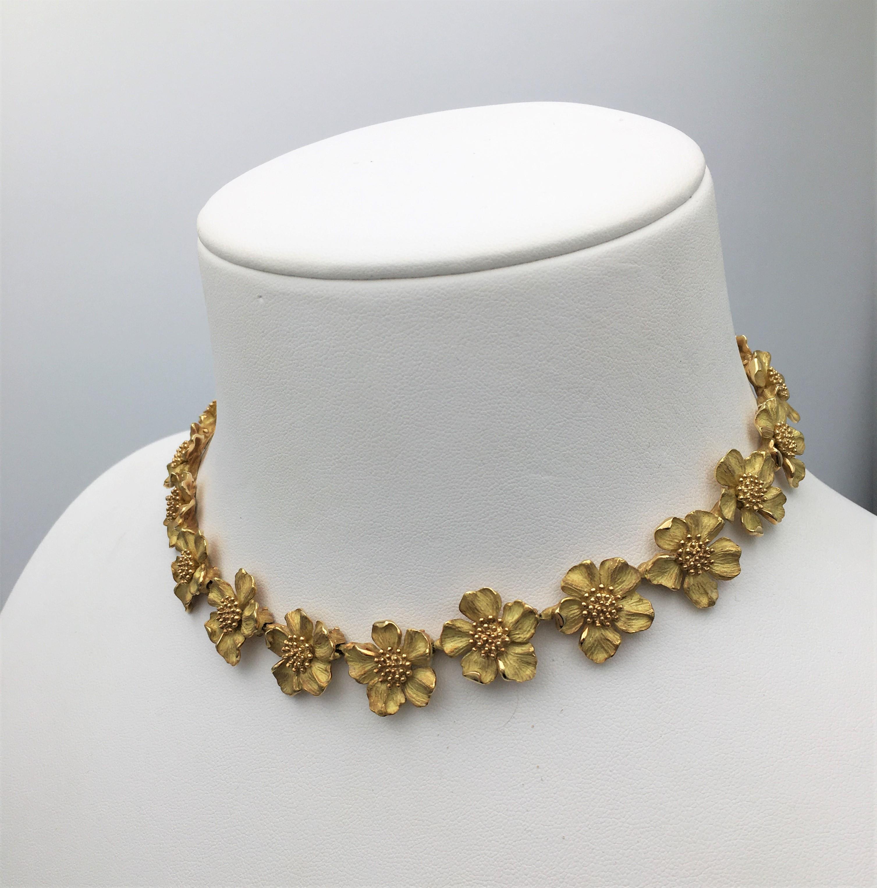 Authentic classic Tiffany & Co. Dogwood flower link necklace crafted in textured 18 karat yellow gold. Signed Tiffany & Co., Tiffany Classics, 750. The necklace measures 16 inches in length. Presented with original pouch, no box or papers. CIRCA