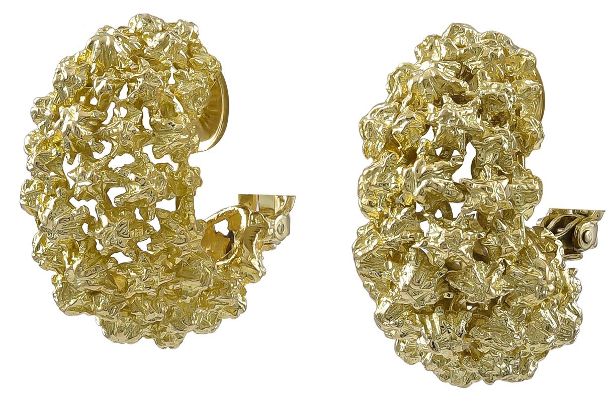 Large gold ear clips, with intricate openwork.  Made,signed and numbered by TIFFANY & CO.  Heavy gauge 18K yellow gold with a brilliant metallic foil finish.  Clip backs, with attached comfort cushions.  1