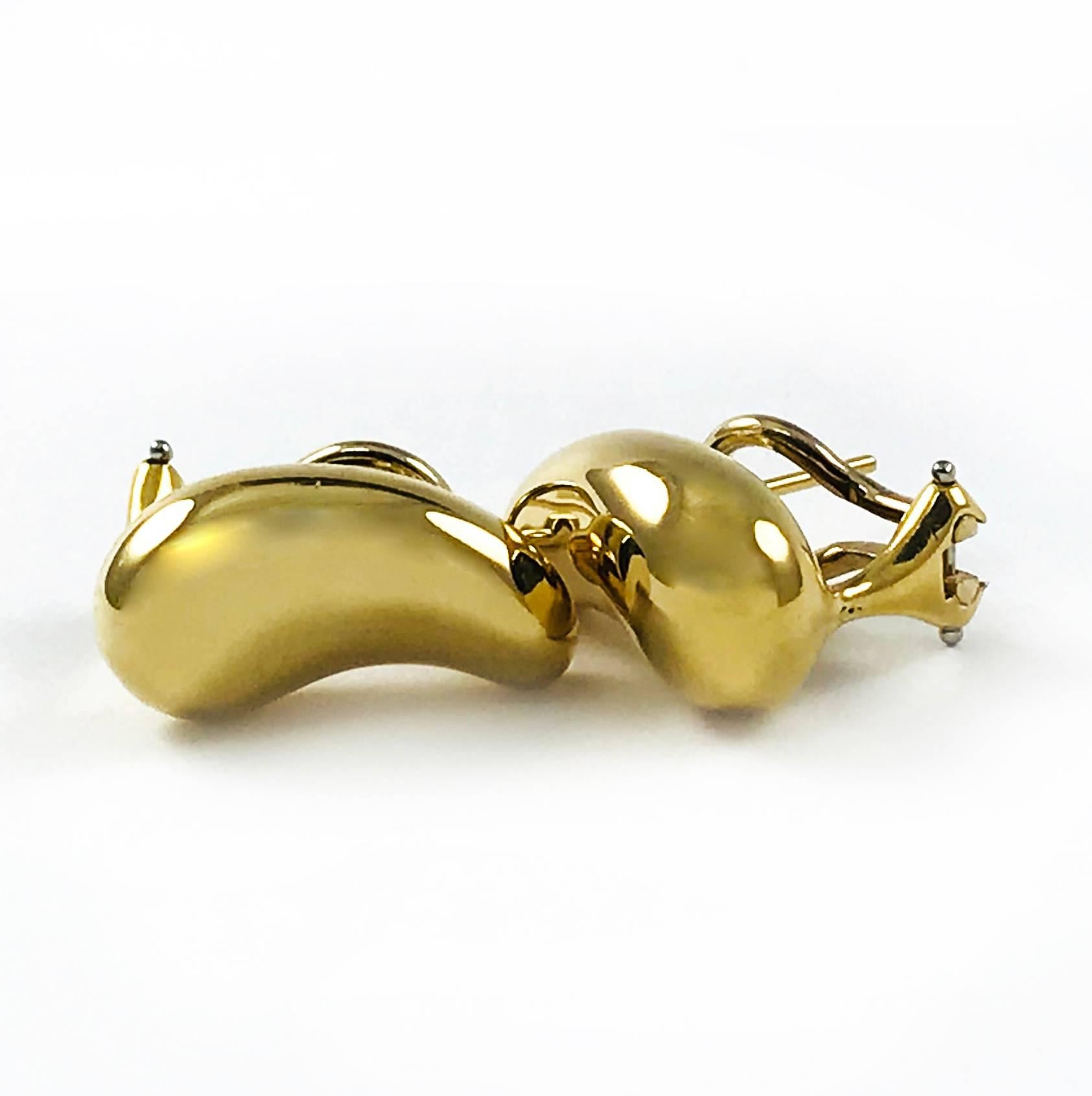 Tiffany & Co. 18k Yellow Gold Elsa Peretti “Bean” Earrings. Elsa Peretti's sensual, organic shapes delight the eye. Peretti explores nature with the acumen of a scientist and the vision of a sculptor. She allows us to see such forms as the 