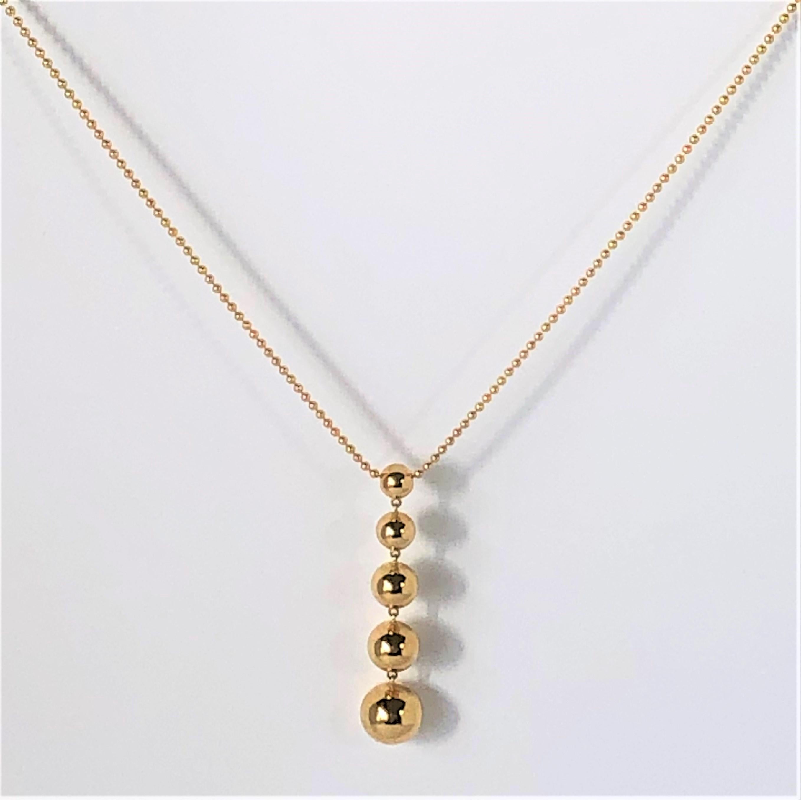 Made by Tiffany & Co, this wearable, great, every day 18K yellow gold necklace
is ideal for women of all ages. The necklace measures 16 inches long and the 5 ball pendant measures just over 1 7/8 inch long. The gold balls graduate from 10mm