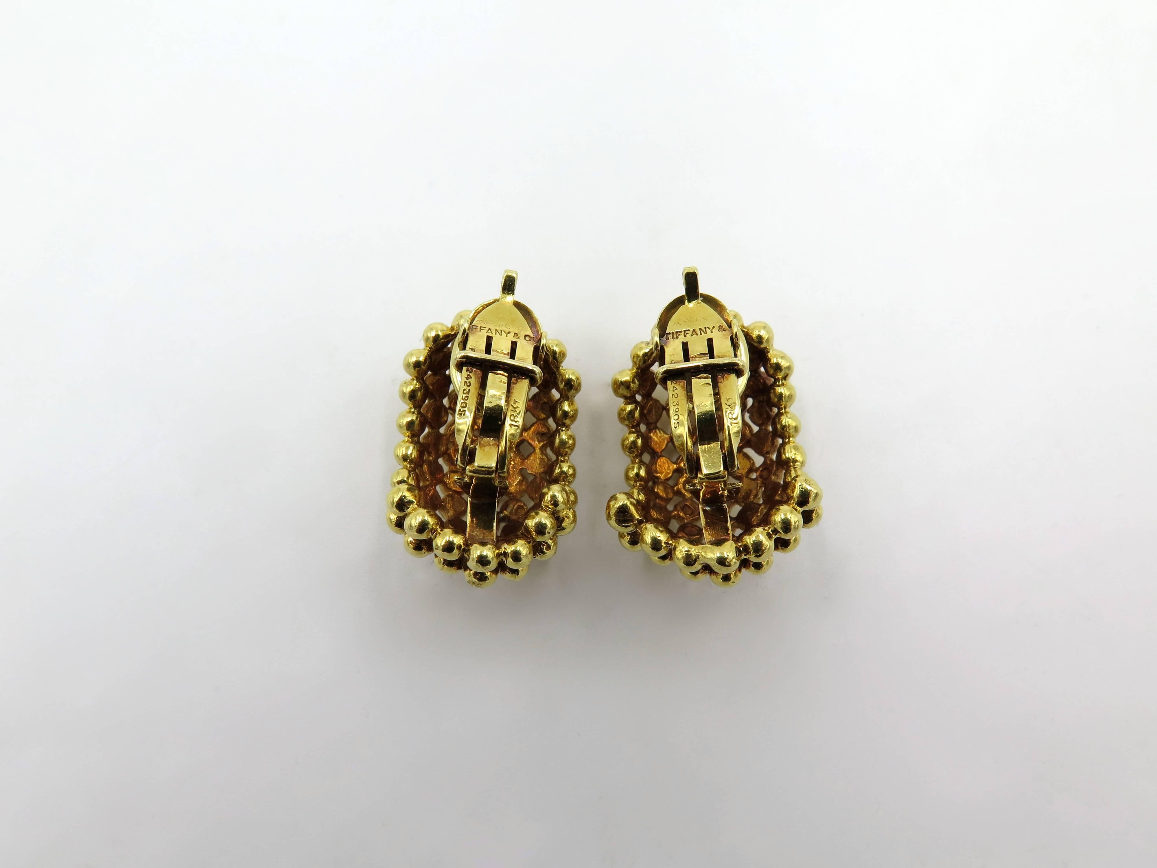 A pair of 18 karat yellow gold earrings. Tiffany & Co. Circa 1980. Designed as a beaded bombe half hoop. Length is approximately 1 inch. Gross weight is approximately 29.3 grams. Numbered 31601.