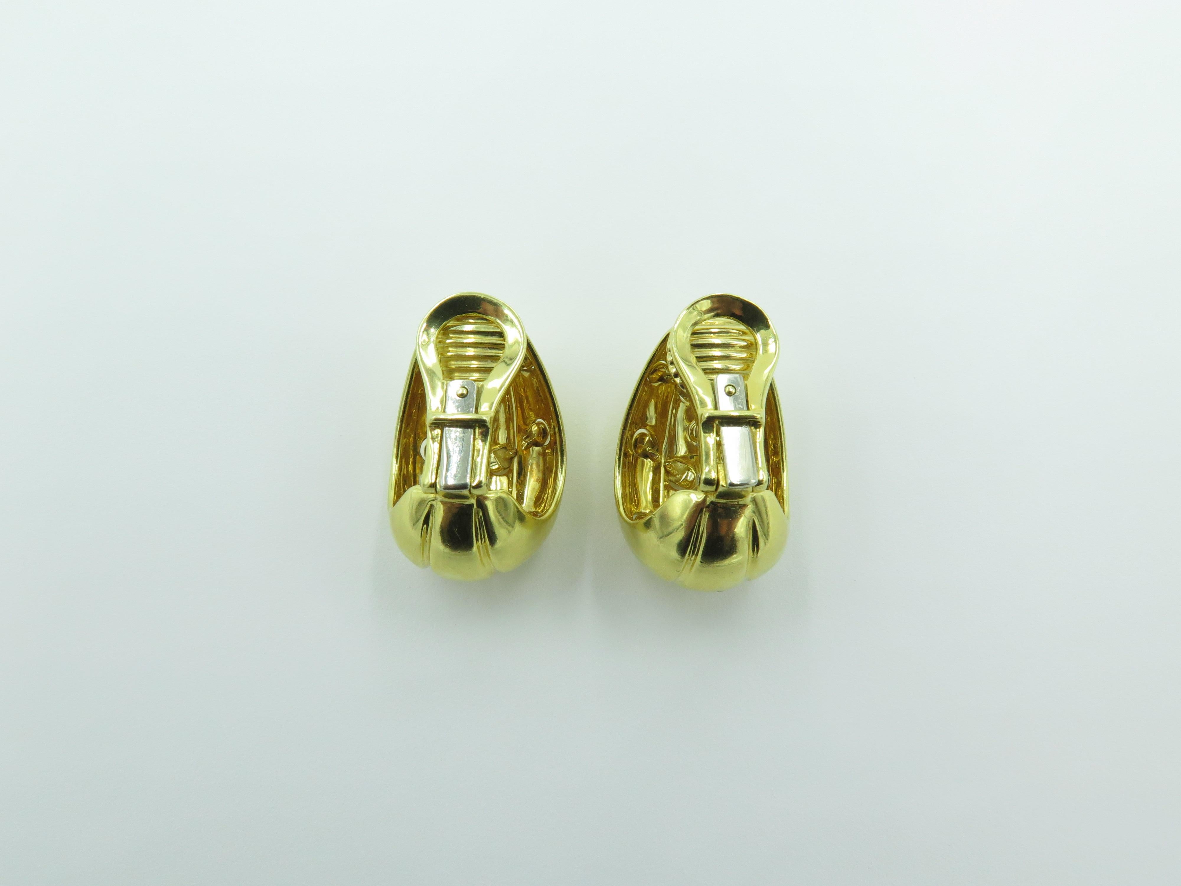 A pair of 18 karat yellow gold earrings. Tiffany & Co. Designed as polished gold half hoops, enhanced by a cross stitch pattern. Length is approximately 1 inch. Gross weight is approximately 22.1 grams.