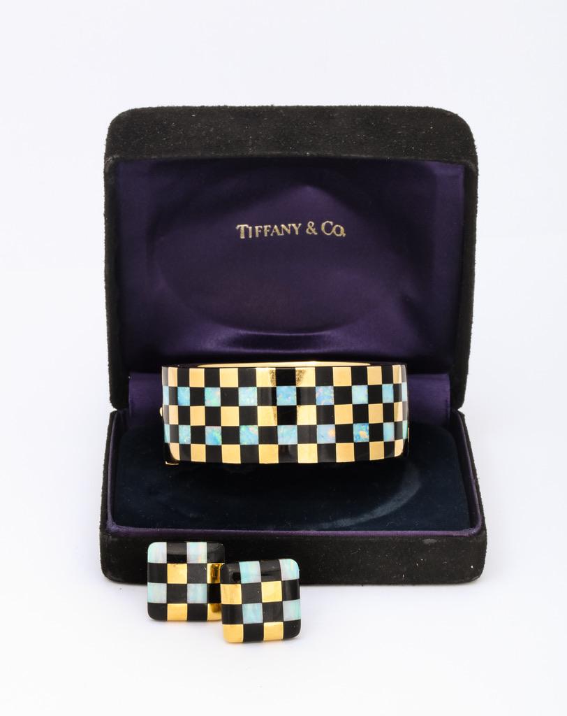 Australian opals were perfectly cut to contrast with the black onyx and yellow gold.  Bold, stylish and unique best describe this rare set by Tiffany & Co.  
Bracelet: 6 1/2