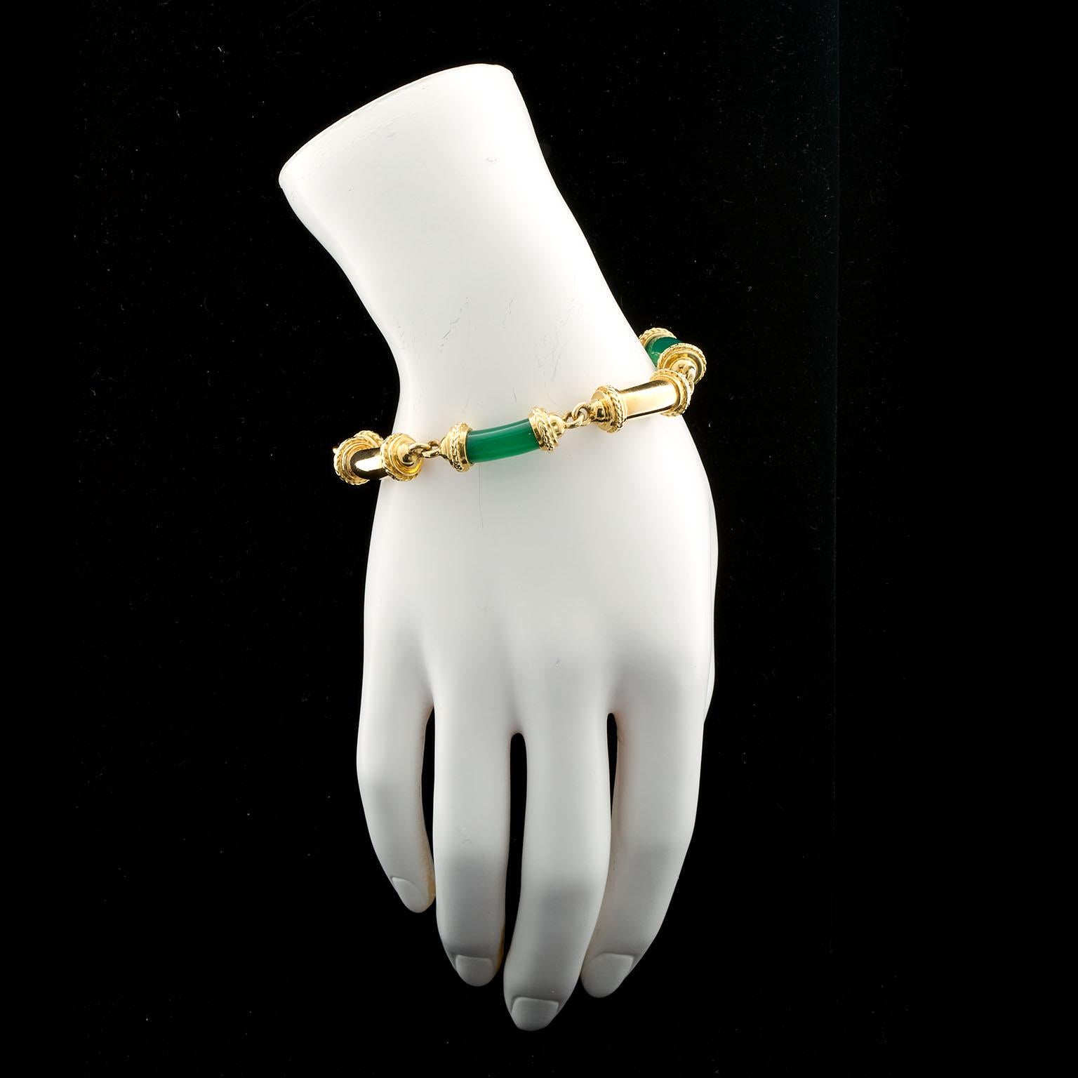 A vintage tubular sectional bracelet featuring three jade green Chalcedony tubes and three 18k gold tubes. Signed Tiffany & Co. Possibly 1940s.

Measures: 7-7/8 inches long.

No. TMWJ-5847