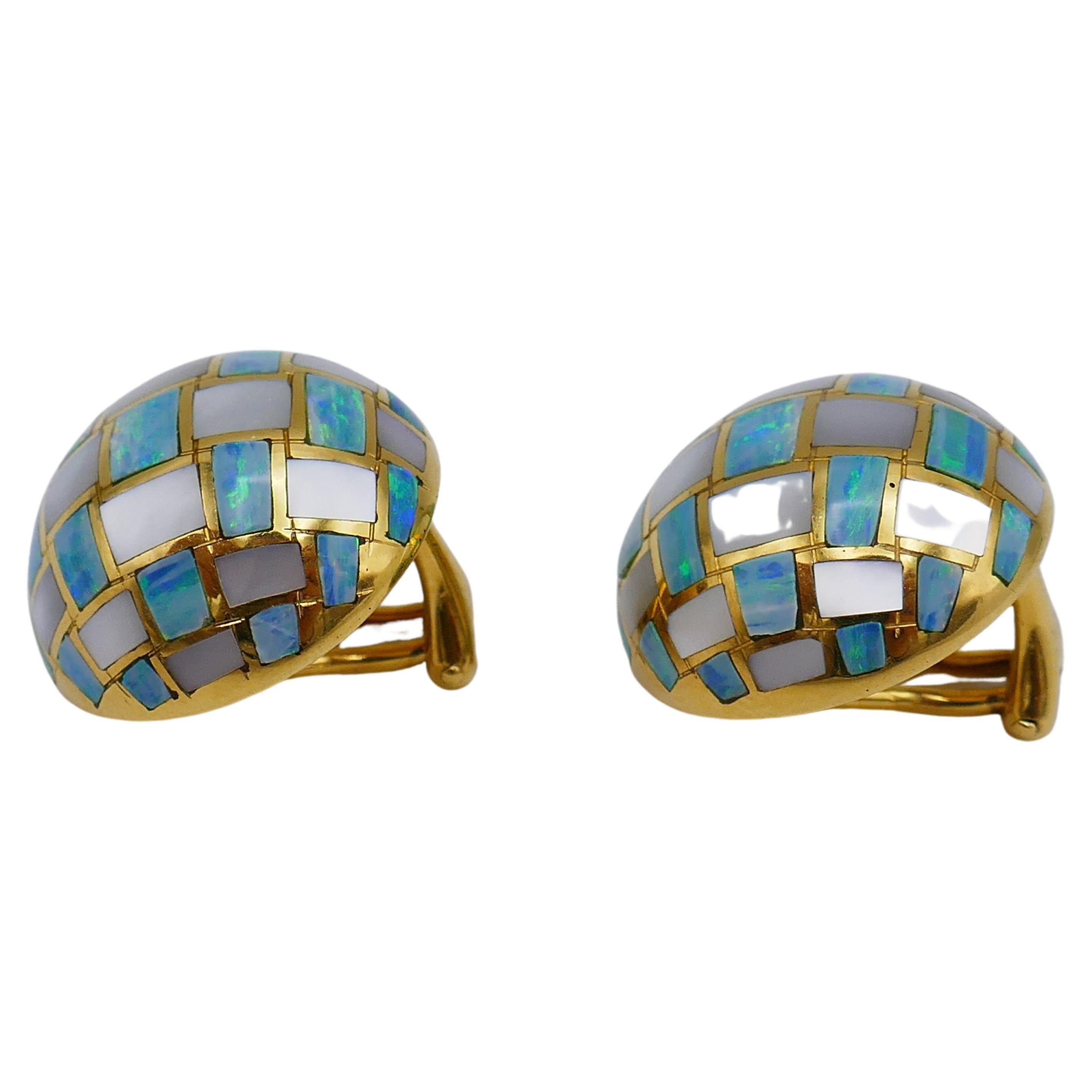 A pair of vintage (c. 1980s) yellow gold mother-of-pearl dome earrings with inlaid opal. Stamped with  Tiffany & Co. maker's mark and a hallmark for 18k gold. 
Measurements: the diameter is 13.6 grams. The weight is 13.6 grams