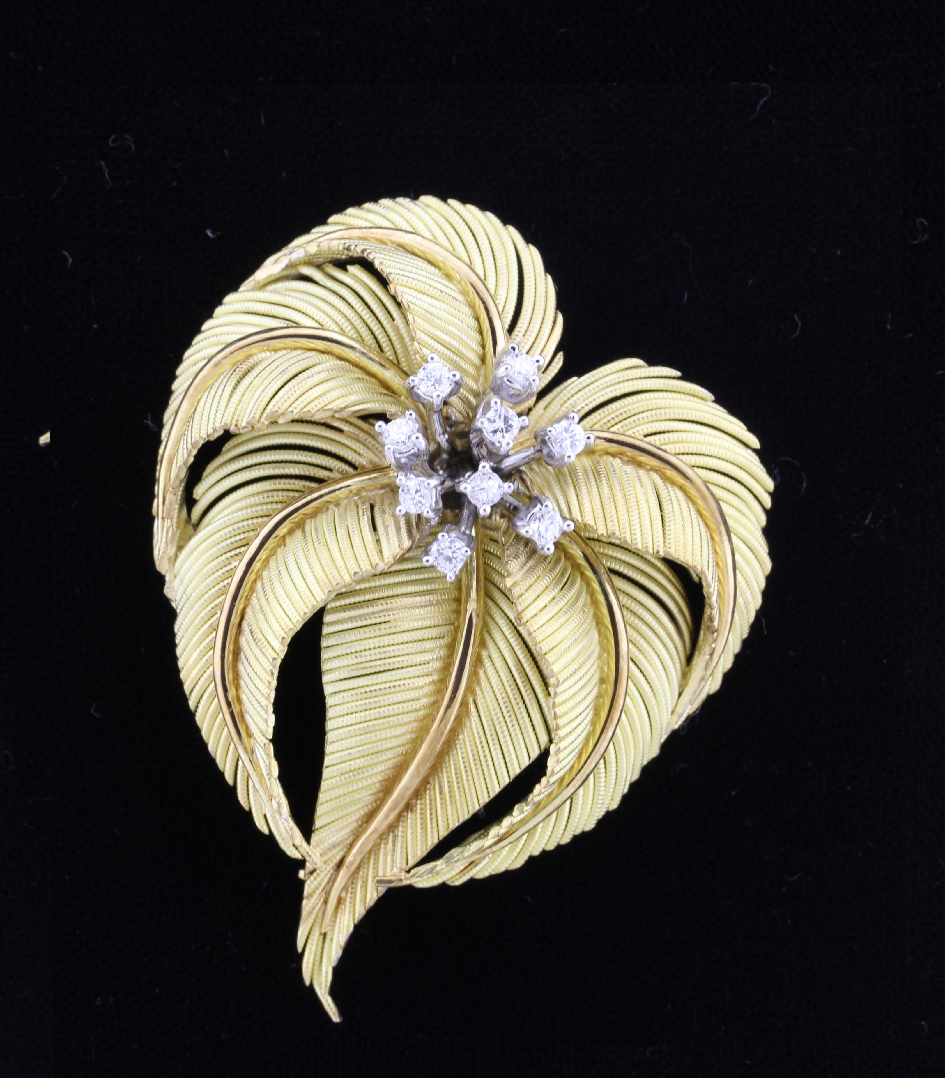 From Tiffany & Co. a series of gold palms form a dynamic diamond  gold brooch
• Designer:  Tiffany & Co.
•  18 karat gold with platinum settings
•  Circa: 1990s
•  Size: 2¼ by 1¾
•  9 Diamond: weigh .45 carats
•  Packaging: Tiffany box
• Condition: