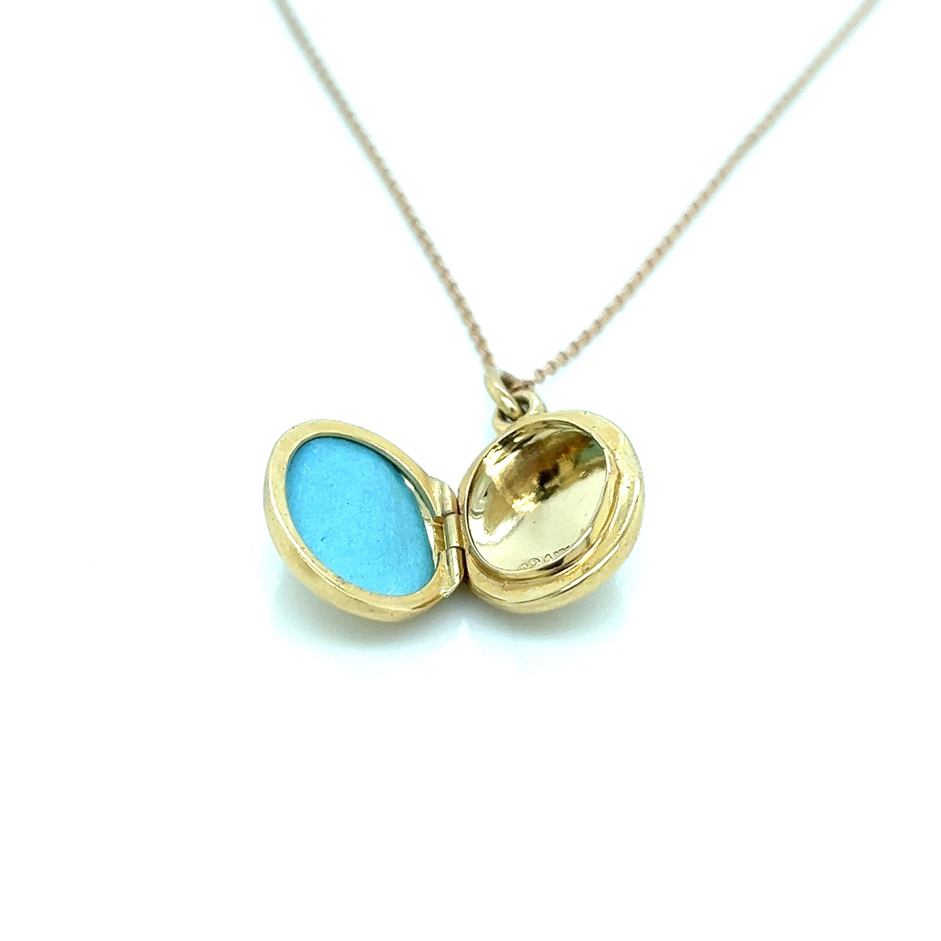 Tiffany & Co 14k gold vintage oval locket pendant, suspended on a T & Co 18k gold chain. Necklace is 16