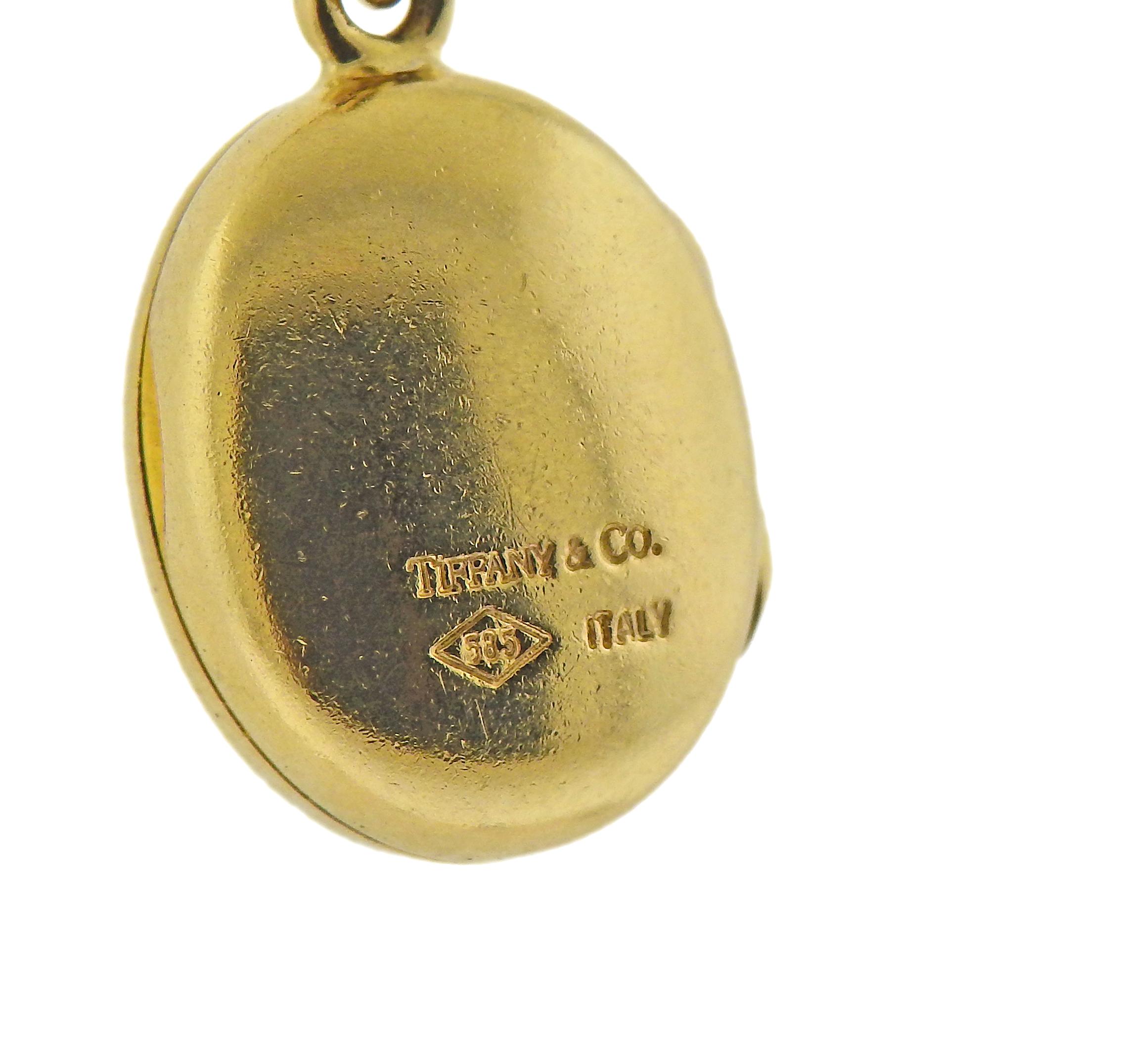 18k gold Tiffany & Co chain necklace with suspended oval 14k gold locket pendant. Necklace is 16