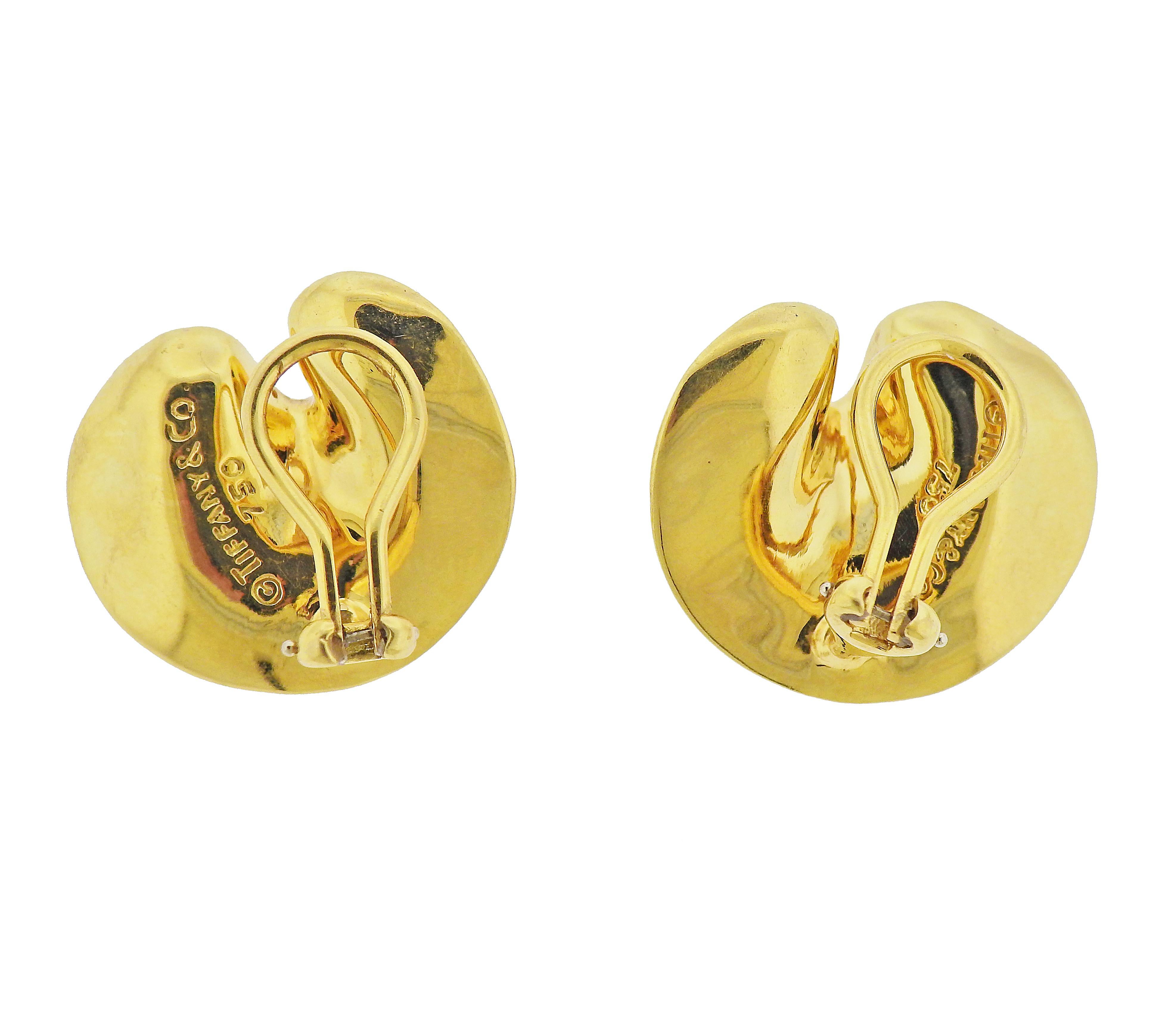 Pair of 18k gold petal earrings by Tiffany & Co. Earrings are 21mm x 23mm. Marked: Tiffany & Co, 750. Weight - 13.8 grams.