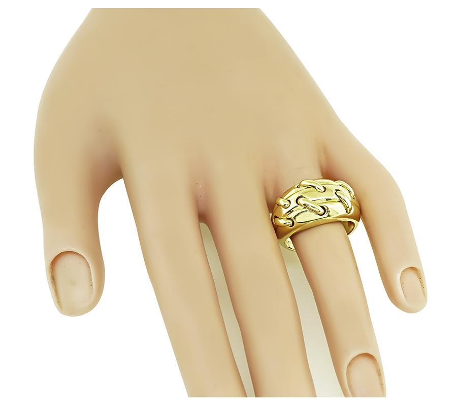 This is an elegant 18k yellow gold ring by Tiffany & Co. The ring has a tapering width from 5mm to 13mm. The ring is signed TIFFANY&Co Au 750 and weighs 10.8 grams. The ring is size 8 3/4 but it can be resized.