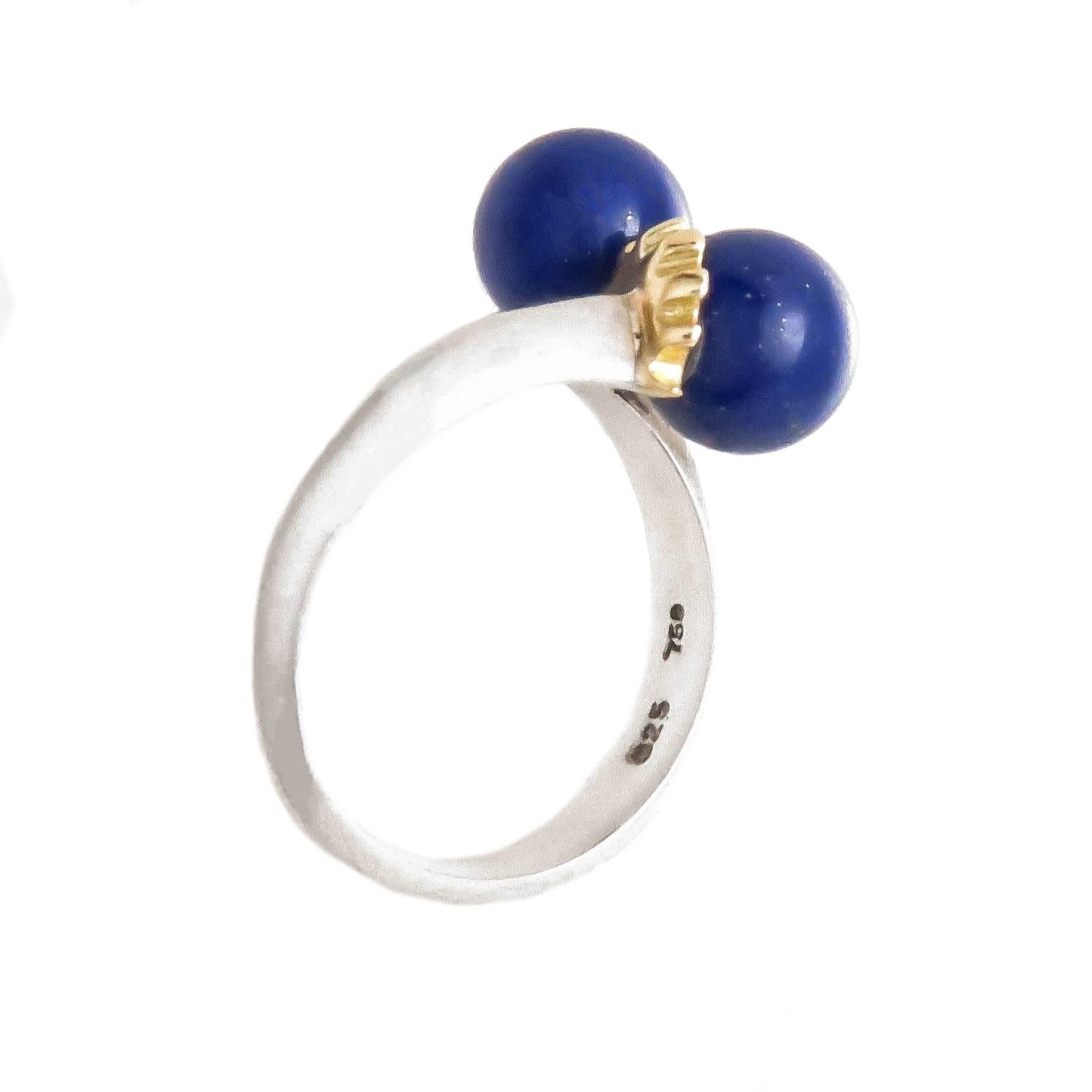 Circa 1980s Tiffany & Company Sterling Silver 18K yellow Gold and Lapis Ring,  Set with 2 Round Lapis Lazuli stones each measuring 7 MM.  Finger size 5 1/2.