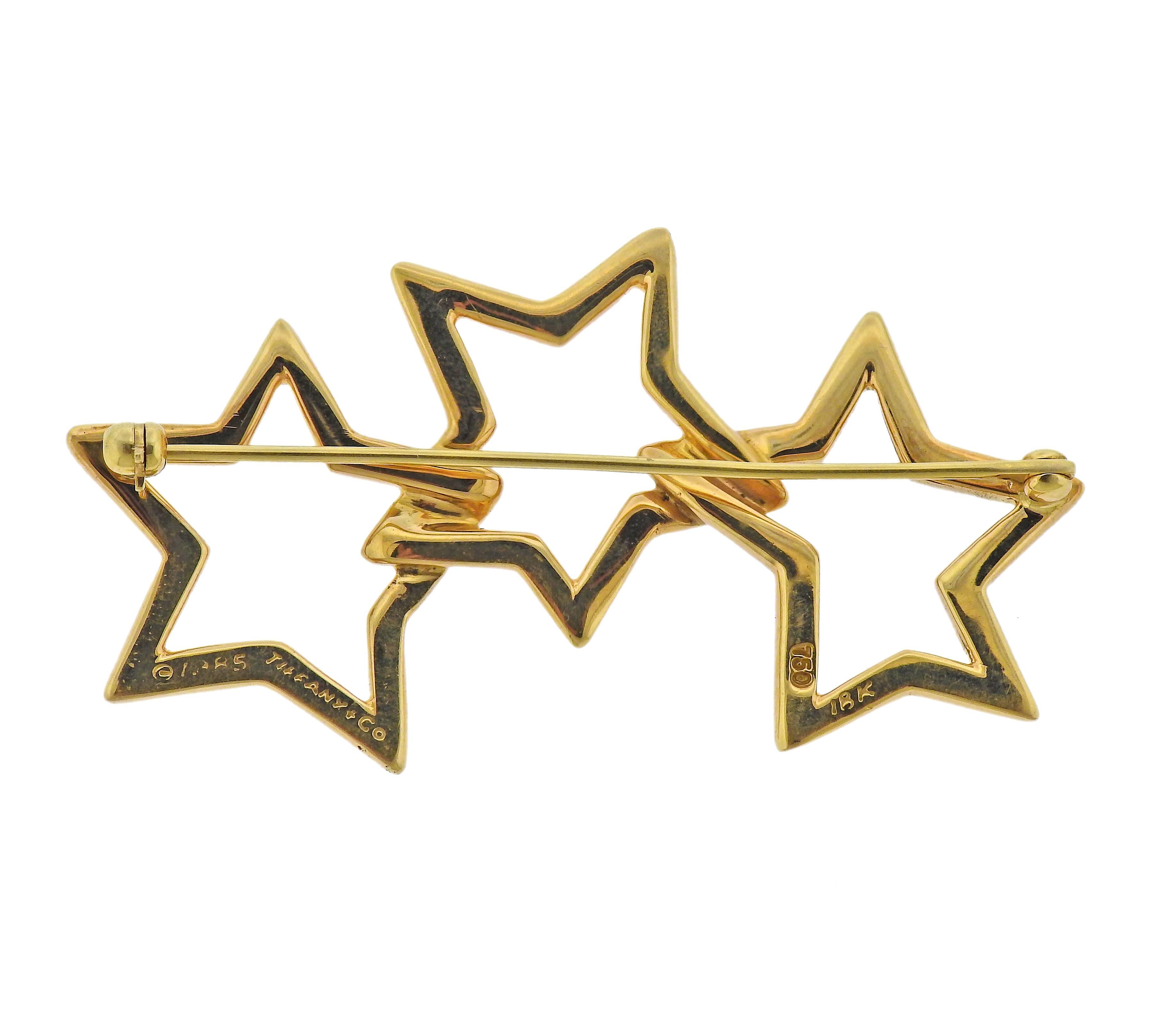 18k gold circa 1985 Tiffany & Co three stars brooch. Measuring 55mm x 28mm wide. Marked: Tiffany & Co, 18k, 1985. Weight - 12.9 grams. 