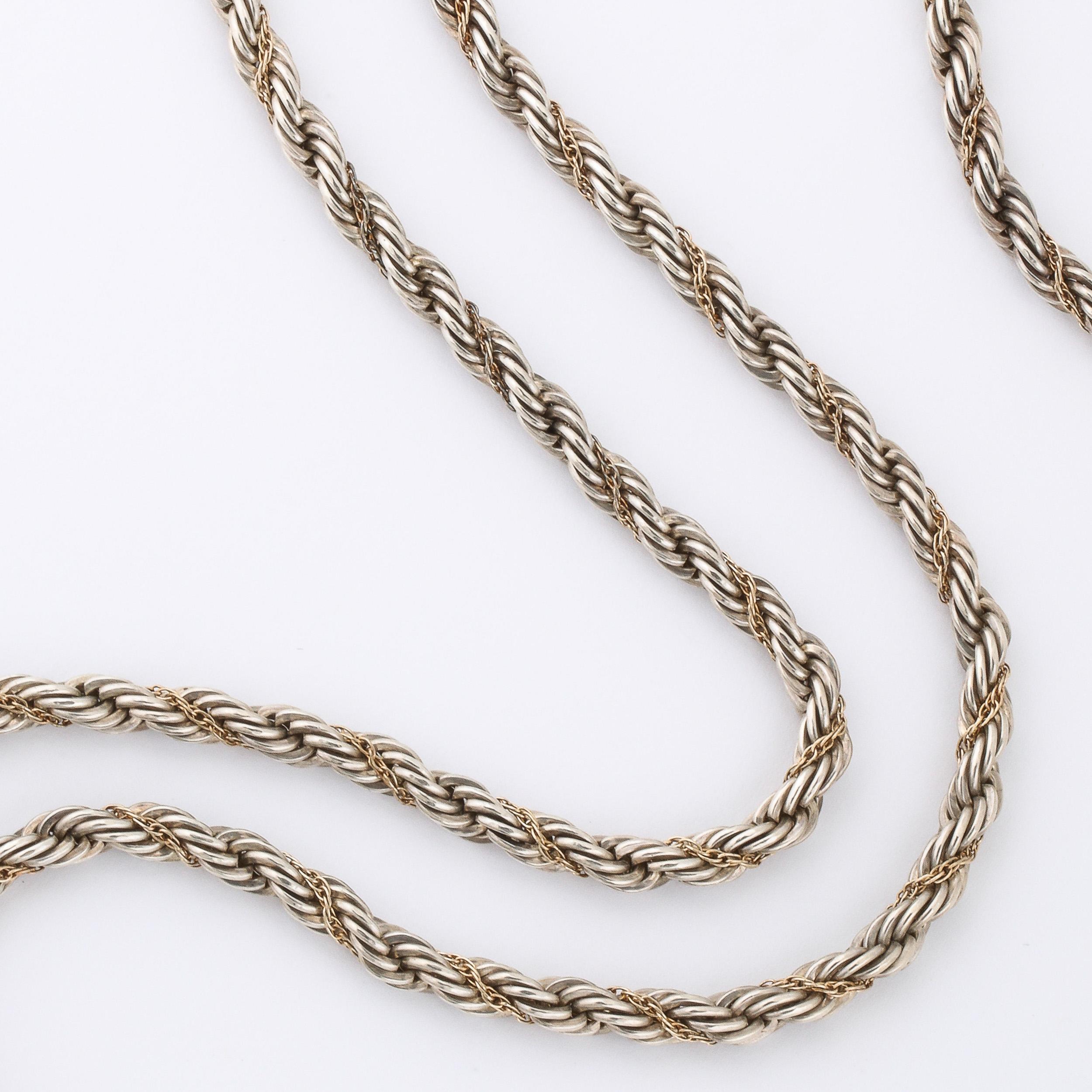This Vintage Tiffany & Co twist rope chain necklace is sterling silver and 14k yellow gold .It is 35.5 inches long allowing the wearer to either wear it at one length or double loop it as well . It is fitted with a lobster closure and marked